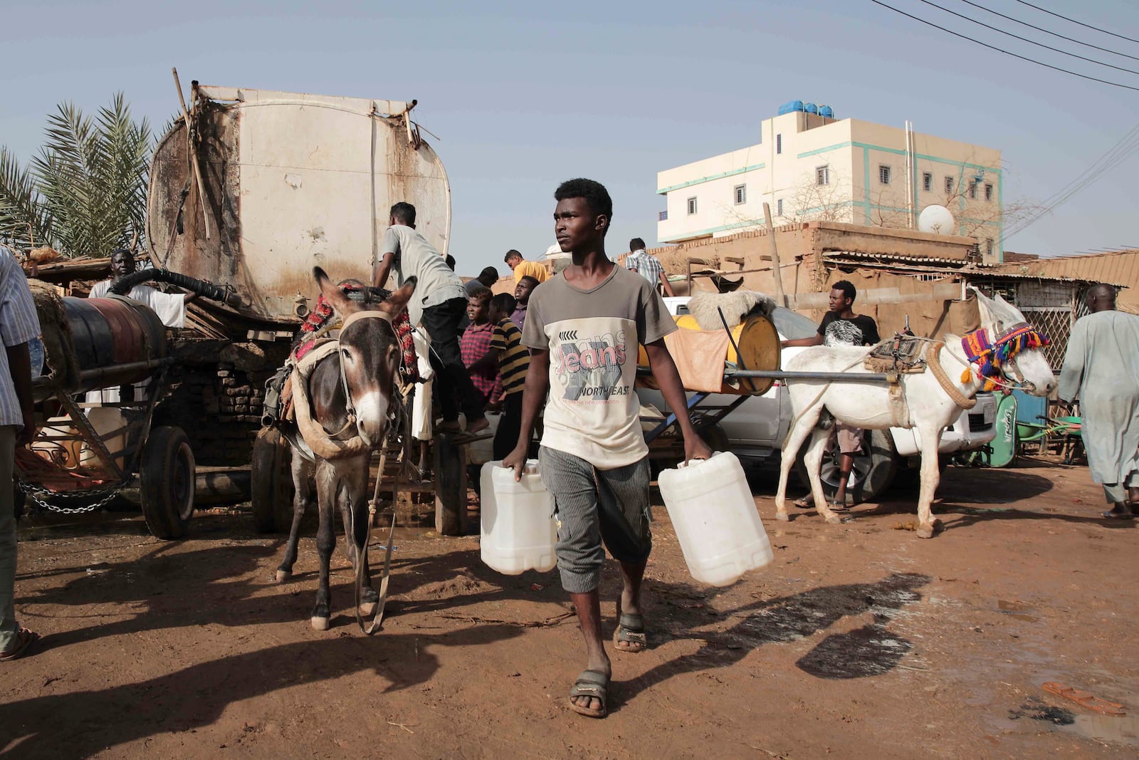 FILE - People gather to collect water in Khartoum, Sudan, May 28, 2023. (AP Photo/Marwan Ali, File)