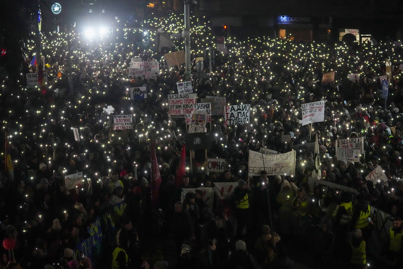 People protest in front of the state-run TV headquarters, a day after a young student protester was hit by a car and seriously wounded in Belgrade, Serbia, Friday, Jan. 17, 2025. (AP Photo/Darko Vojinovic)