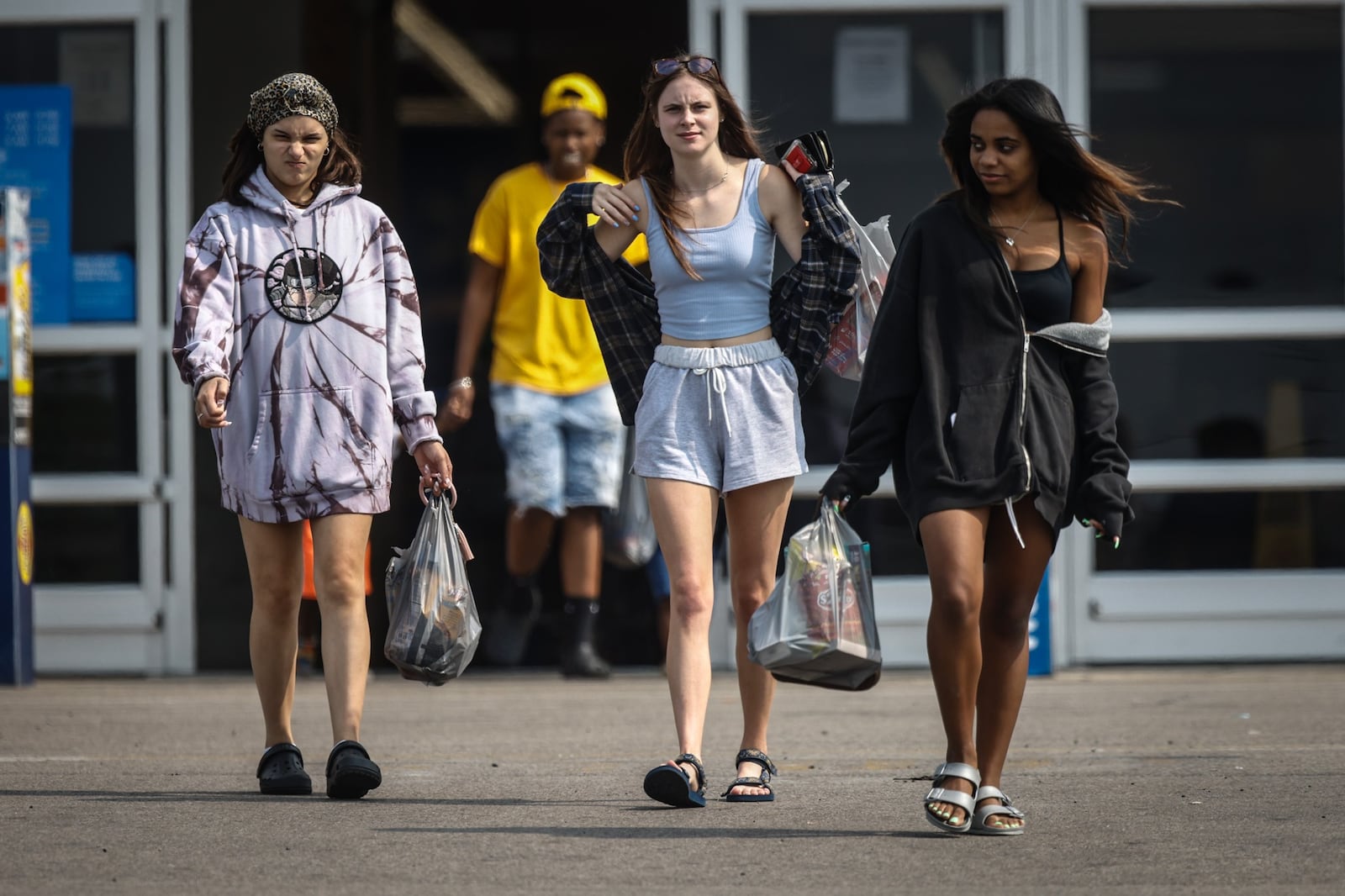 College students from left, Gabby Famal, Gabrielle Schneider and Kennedy Byrd exit Walmart after shopping Thursday July 29, 2021.The CDC recommended on Tuesday that in areas with high community COVID-19 transmission rates, fully vaccinated individuals should don a face mask. All three women are from Dayton.  JIM NOELKER/STAFF