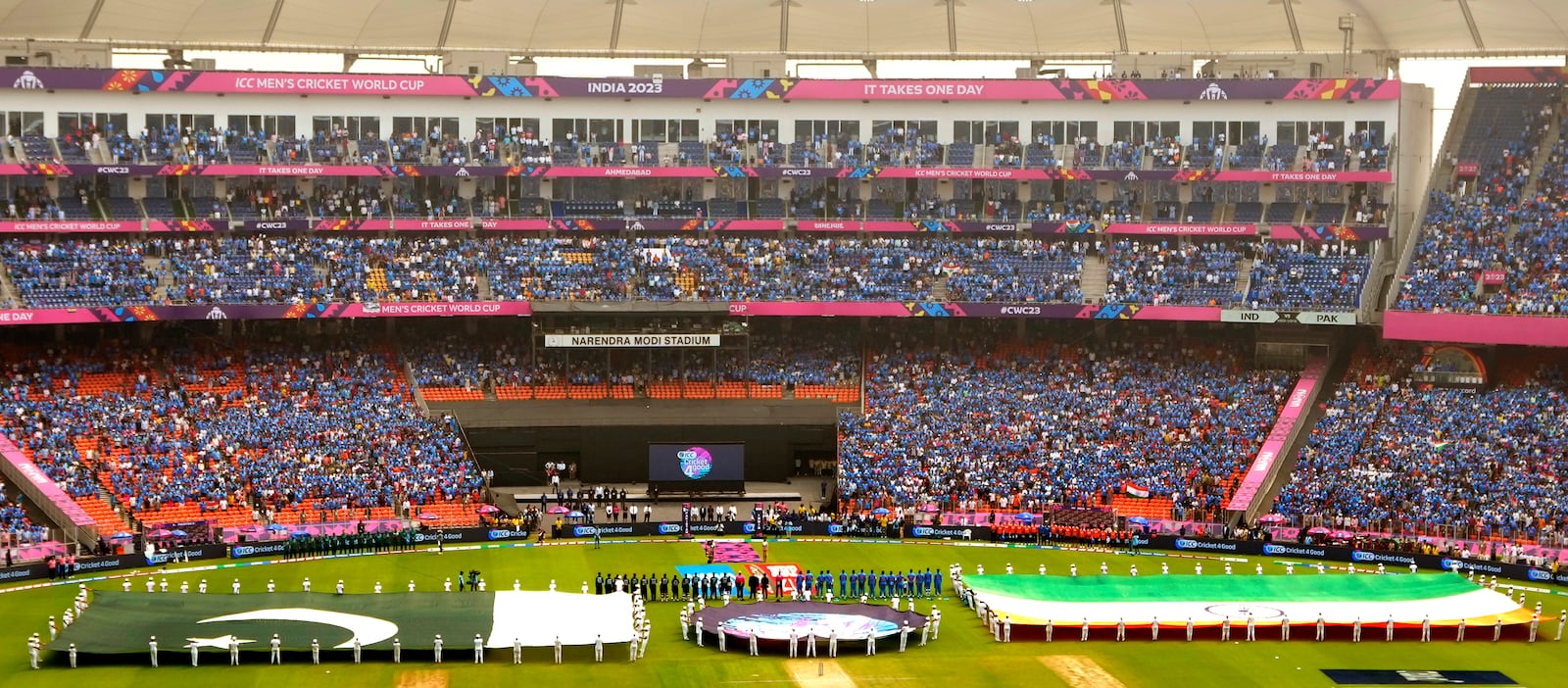 Large national flags of India and Pakistan are carried by children as the national anthems are played before the start of the ICC Men's Cricket World Cup match between India and Pakistan in Ahmedabad, India, Oct. 14, 2023. (AP Photo/Ajit Solanki, File)