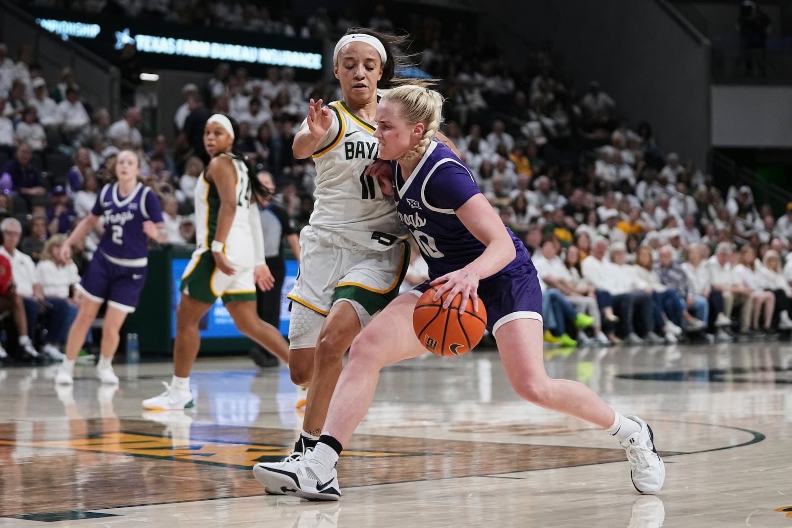 TCU guard Hailey Van Lith, right, drives to the basket as Baylor's Jada Walker (11) defends in the second half of an NCAA college basketball game in Waco, Texas, Sunday, March 2, 2025. (AP Photo/Tony Gutierrez)