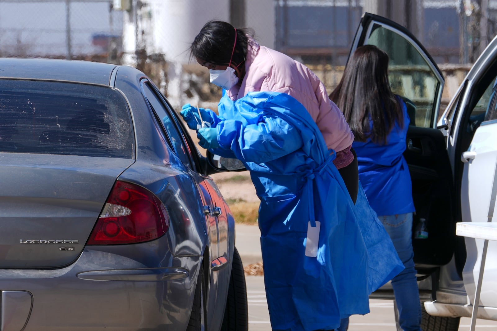 A health worker administers a measles test to a car passenger at a mobile testing site outside Seminole Hospital District Friday, Feb. 21, 2025, in Seminole, Texas. (AP Photo/Julio Cortez)