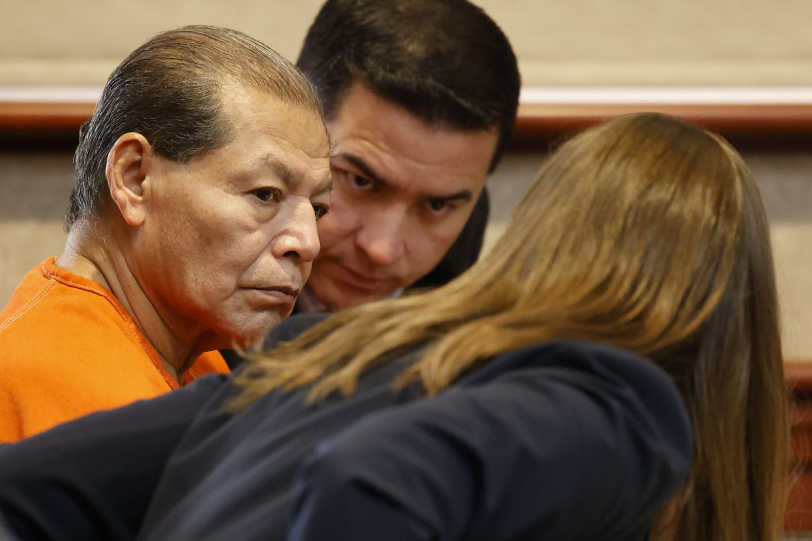 Antonio Riano, 63, is charged with the 2004 murder of Benjamin Becarra, 25, in Hamilton. He fled the country until a couple of years ago when federal and Mexican authorities arrested Riano and subsequently extradited to the United States in August 2024. Pictured is Riano (center) is in court on March 14, 2025, listening to his attorney, Kara Blackney during a suppression hearing. An interrupter is at Riano's left. NICK GRAHAM/STAFF