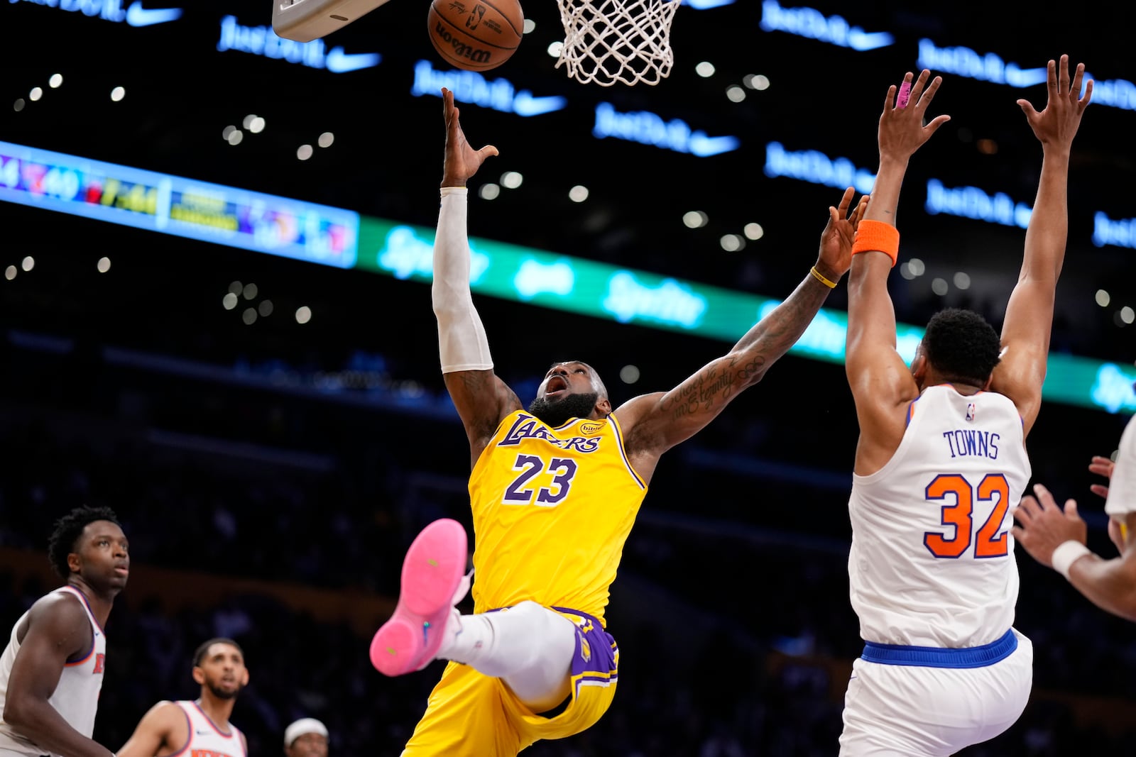 Los Angeles Lakers forward LeBron James (23) shoots as New York Knicks center Karl-Anthony Towns (32) defends during the first half of an NBA basketball game Thursday, March 6, 2025, in Los Angeles. (AP Photo/Mark J. Terrill)