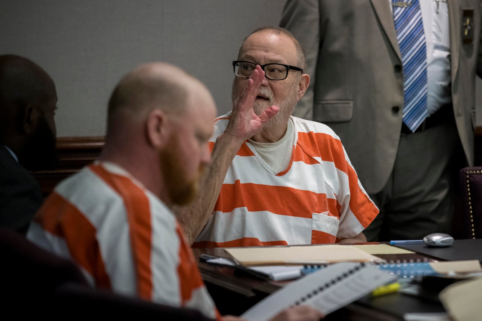 Greg McMichael waves in the direction of his wife sitting the gallery during a hearing challenging his trial for killing Ahmaud Arbery in 2020, Thursday, Oct. 24, 2024, in Brunswick, Ga. (AP Photo/Stephen B. Morton)