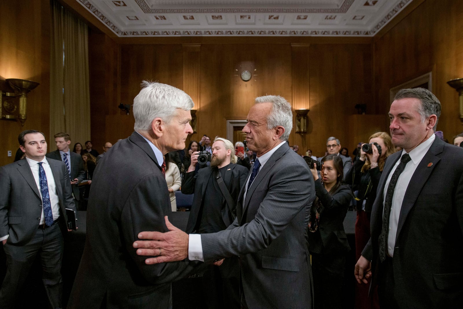 Robert F. Kennedy, Jr., right, President Donald Trump's nominee to serve as Secretary of Health and Human Services, talks with Committee Chairman Sen. Bill Cassidy, R-La., following his testimony during a Senate Committee on Health, Education, Labor and Pensions hearing for his pending confirmation on Capitol Hill, Thursday, Jan. 30, 2025, in Washington. (AP Photo/Rod Lamkey, Jr.)