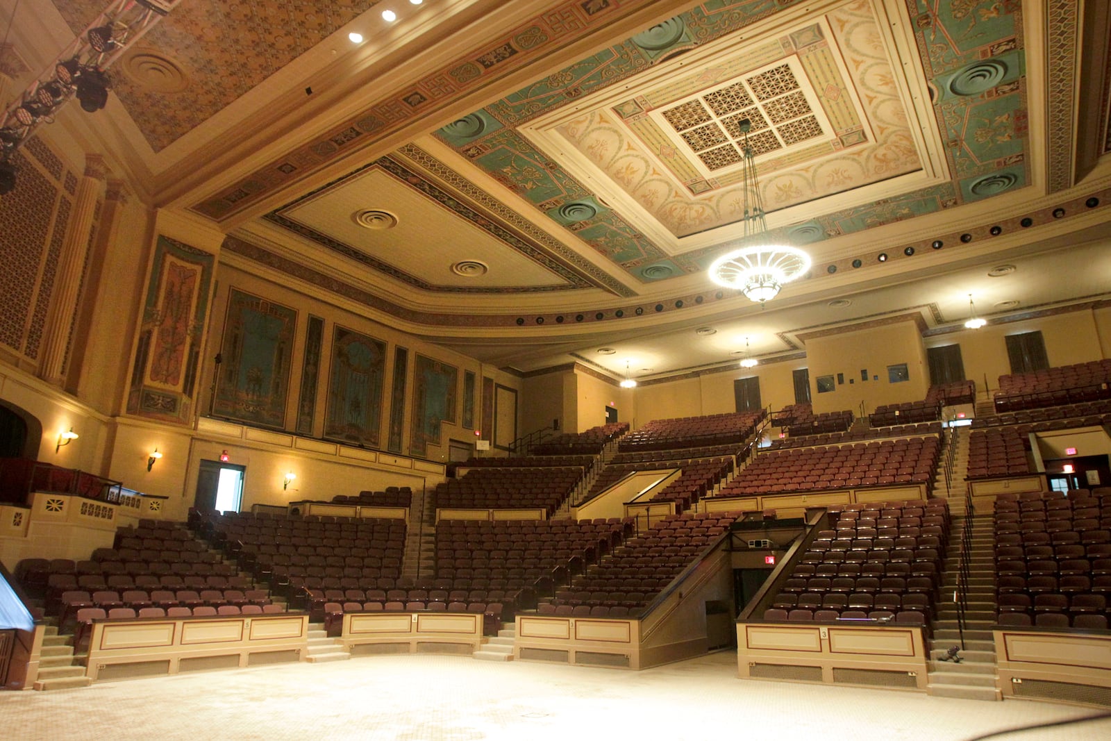 The combination of soaring limestone walls, an Art Deco chandelier and lamps and hand painted murals in the auditorium create a grand concert experience in the Dayton Masonic Center's Schiewetz Auditorium. The floor can be used for seating or as a dance floor for 300 people. LISA POWELL / STAFF