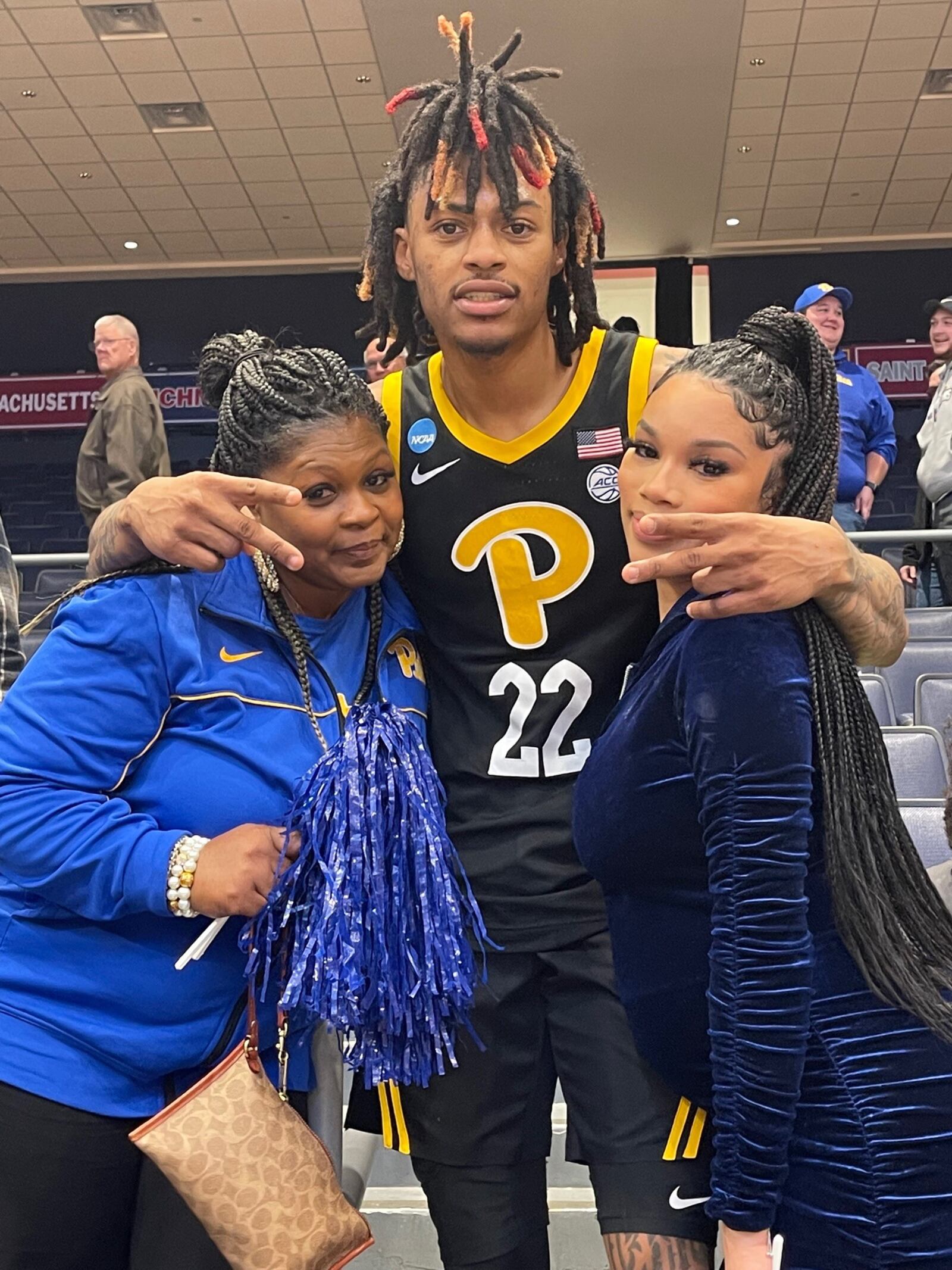 After Pittsburgh's victory over Mississippi State in the First Four on Tuesday night, March 14, 2023, at UD Arena, Panthers guard and former Miami RedHawks star Nike Sibande gets a hug from his mom, Tracy Jones (left) and his fiancé Monique. CONTRIBUTED