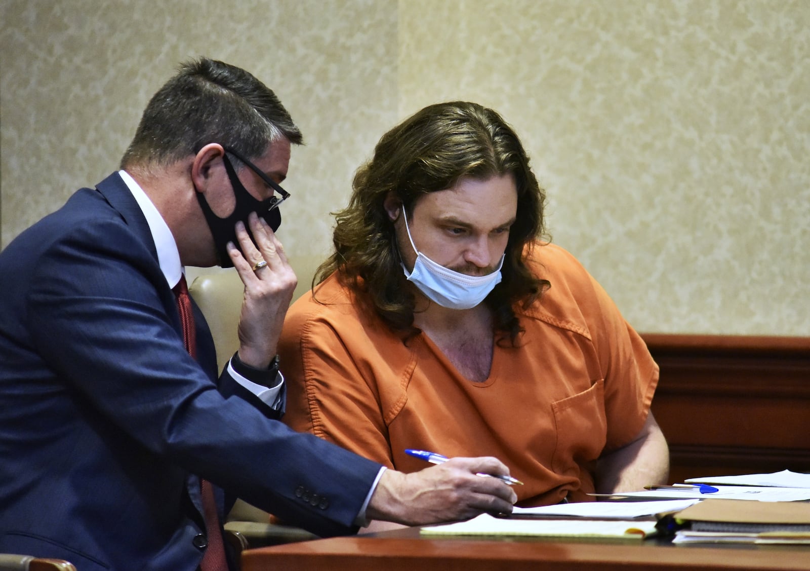 Attorney David Brewer, left, talks with William Slaton during a hearing Thursday in Butler County Common Pleas Court. Slaton is charged with murder and tampering with evidence for allegedly killing a woman and putting her body n a metal drum. NICK GRAHAM/STAFF