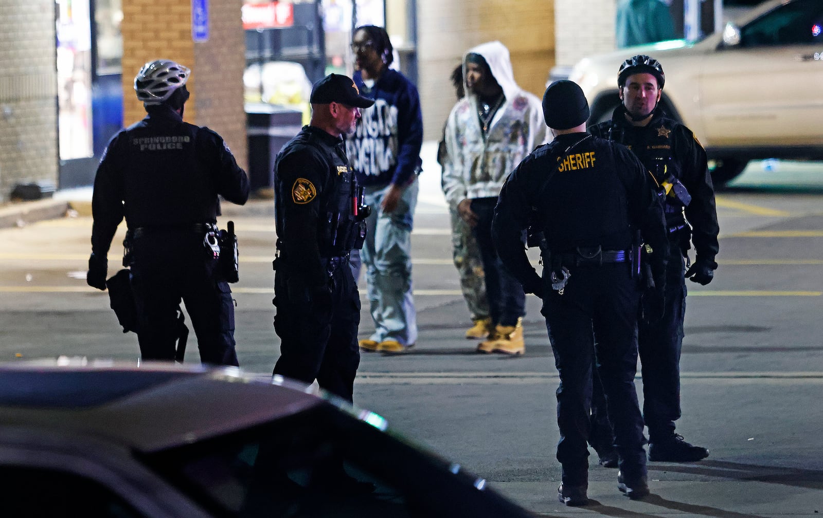 Dayton police officers and officers from other departments disperse crowds in the area of Brown and Stewart Streets near the UD campus Saturday, March 8, 2025. MARSHALL GORBY\STAFF