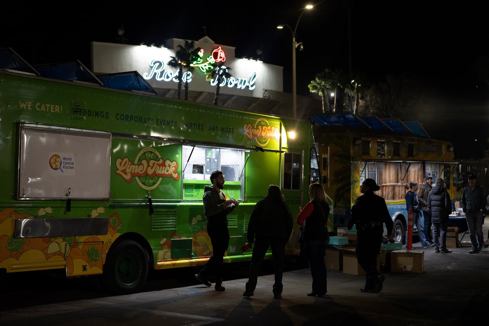 World Central Kitchen Chef Corp member Daniel Shemtob, left, serves Eaton Fire first responders from his food truck, The Lime Truck, at the Rose Bowl Stadium, Wednesday, Jan. 15, 2025, in Pasadena, Calif. (AP Photo/Carolyn Kaster)