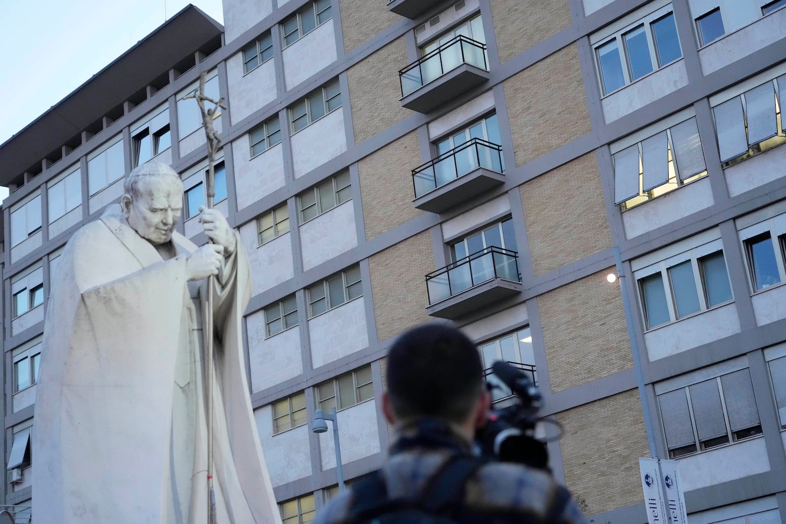 A video journalists films the Agostino Gemelli Polyclinic in Rome, Sunday, Feb. 23, 2025, where Pope Francis is hospitalized since Feb. 14. (AP Photo/Gregorio Borgia)