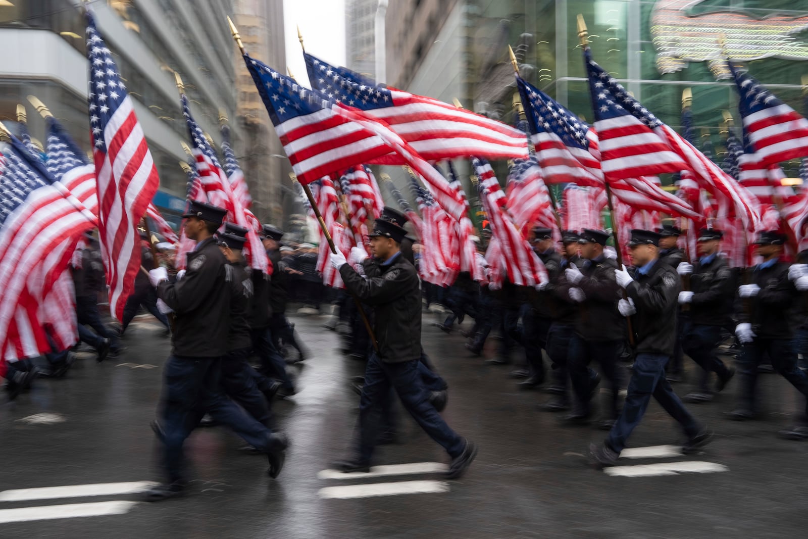 New York Fire Department officers march with flags during the 264th New York City Saint Patrick's Day Parade, Monday, March 17, 2025 in New York. (AP Photo/Adam Gray)