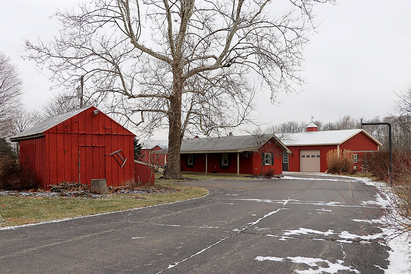 The property includes the original hand-hewn barn with hay lofts, a pole barn with dog kennel, a long house with three separate rooms, a wood shed with nearby fire pit. CONTRIBUTED PHOTO BY KATHY TYLER