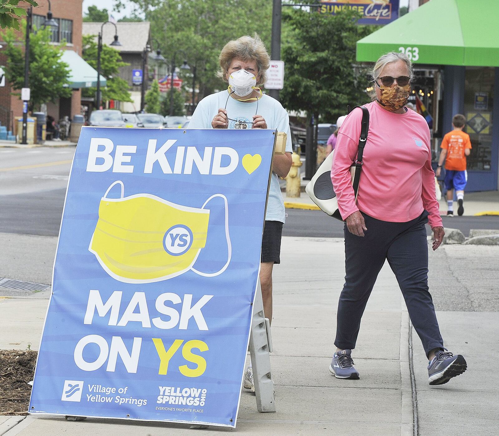 Jeannine Neubauer, left, and Meg Huey, walked around Yellow Springs wearing masks Thursday. The Village passed a resolution to make it a requirement to wear a mask and properly social distance while in the “business district” of Yellow Springs. MARSHALL GORBYSTAFF