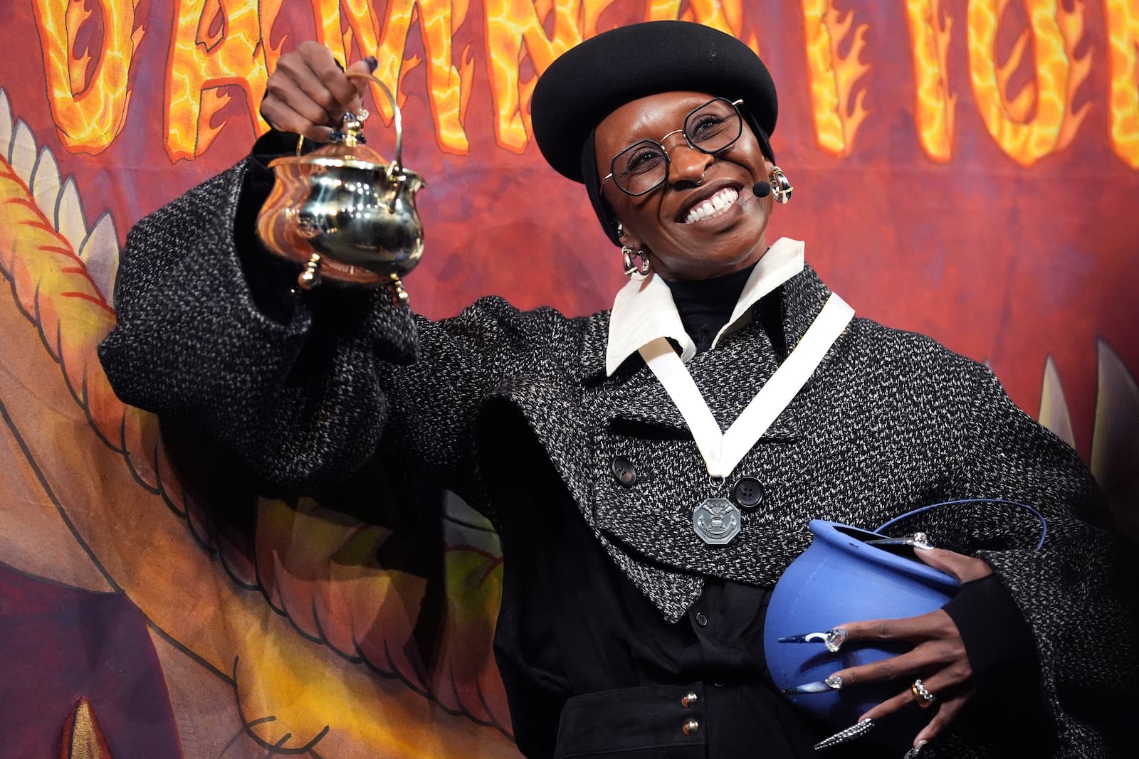 Harvard University's Hasty Pudding Theatricals Woman of the Year Cynthia Erivo hoists her award during a roast, Wednesday, Feb. 5, 2025, in Cambridge, Mass. (AP Photo/Charles Krupa)