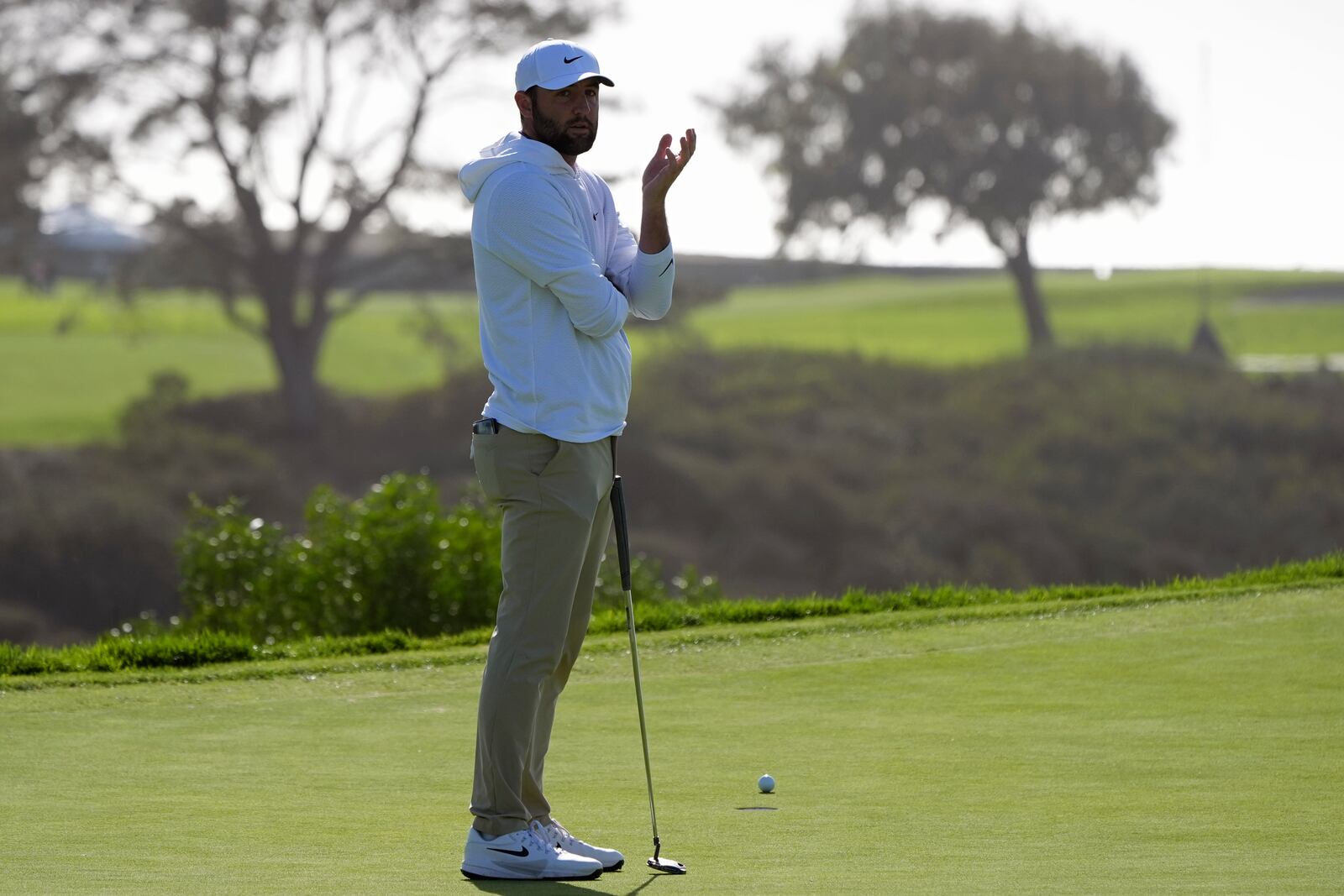 Scottie Scheffler reacts after a double bogey on the 14th hole of the South Course at Torrey Pines during the third round of the Genesis Invitational golf tournament Saturday, Feb. 15, 2025, in San Diego. (AP Photo/Gregory Bull)