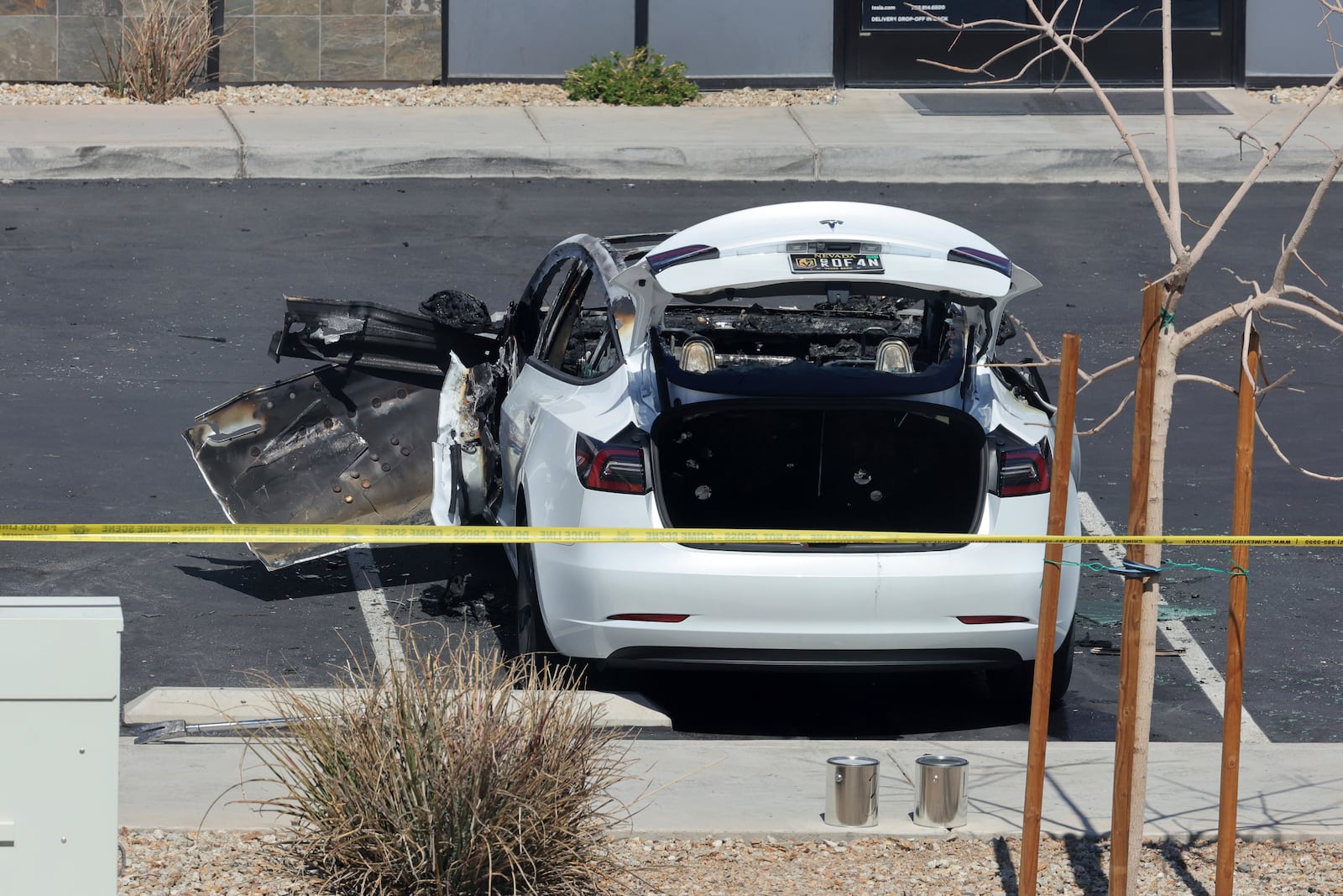 A burned Tesla vehicle is shown at a Tesla collision center Tuesday, March 18, 2025, in Las Vegas. (Steve Marcus/Las Vegas Sun via AP)