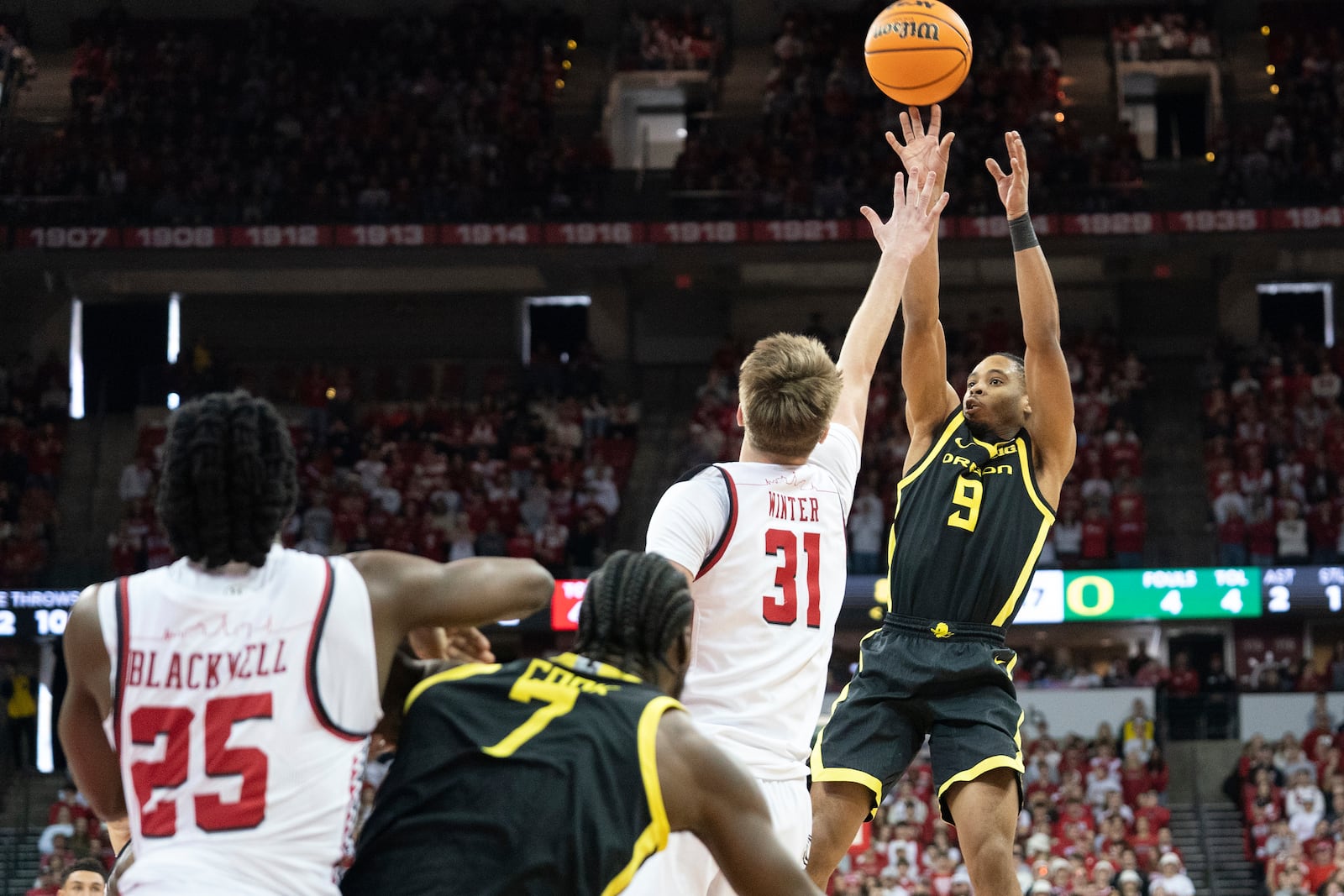 Oregon guard Keeshawn Barthelemy (9) attempts a 3-point basket over Wisconsin forward Nolan Winter (31) during the first half of an NCAA college basketball game Saturday, Feb. 22, 2025, in Madison, Wis. (AP Photo/Kayla Wolf)