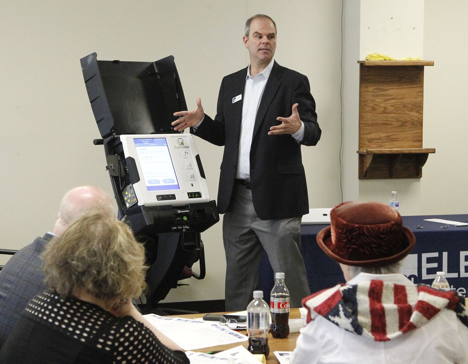 Craig Seibert, regional sales manager, from Election Systems & Software demonstrates a voting machine to the Greene County Board of Elections in Xenia. Dominion Voting Systems machines were demonstrated in a later session.    TY GREENLEES / STAFF