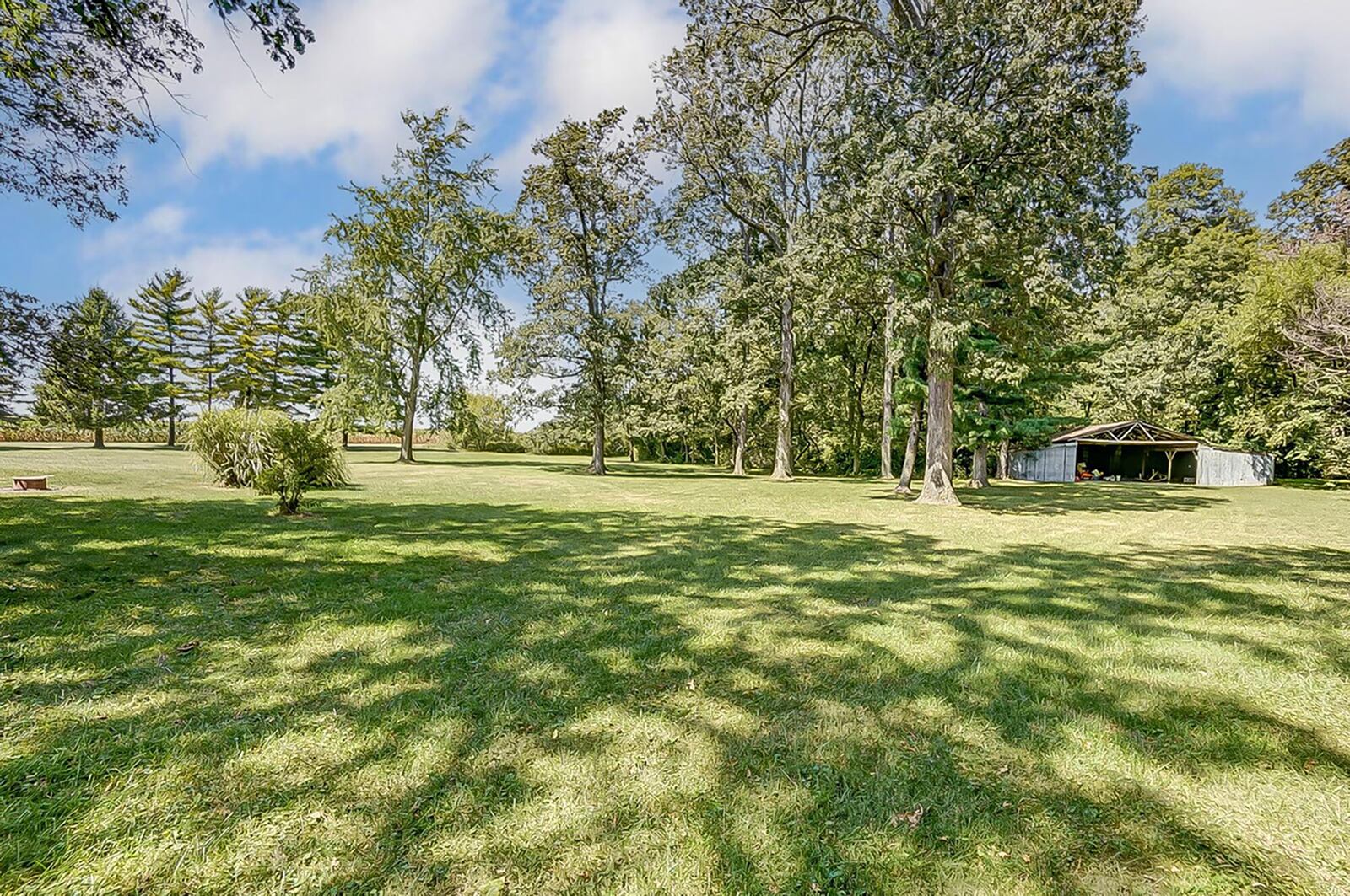 There is a pole barn and firepit on the 7.75 acre property and it is heavily wooded.