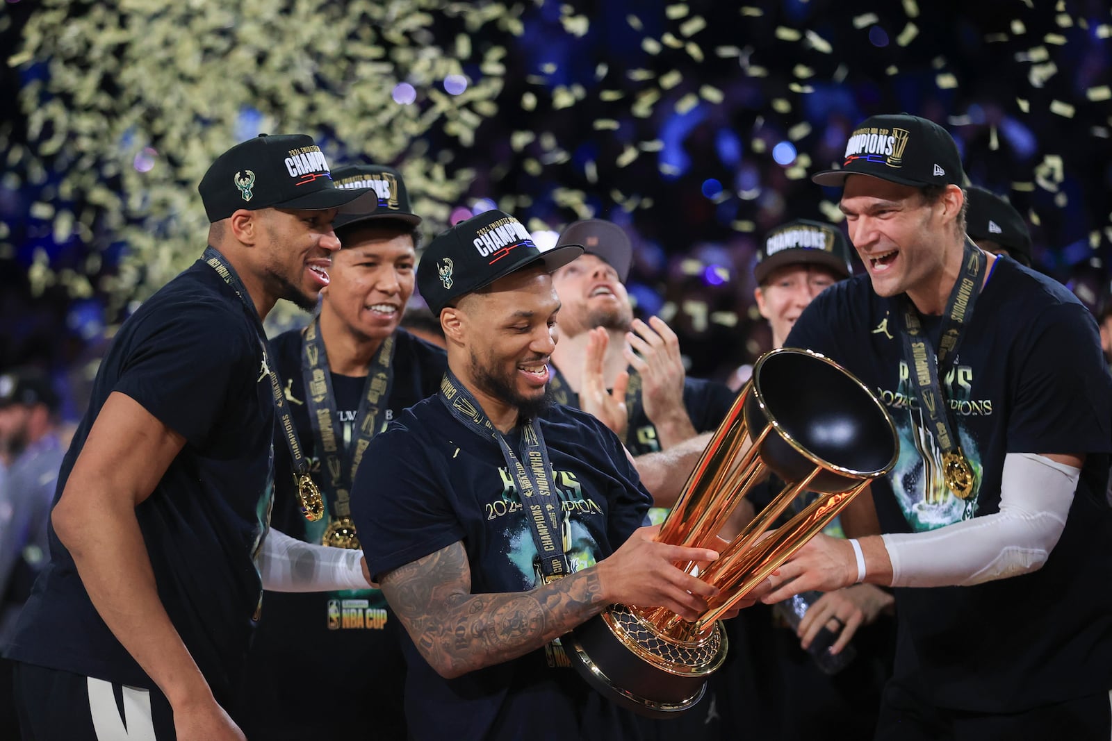 Milwaukee Bucks forward Giannis Antetokounmpo (34), Milwaukee Bucks guard Damian Lillard (0), and Milwaukee Bucks center Brook Lopez (11) celebrate after their team's victory in the championship game of the NBA Cup basketball tournament against the Oklahoma City Thunder Tuesday, Dec. 17, 2024, in Las Vegas. (AP Photo/Ian Maule)