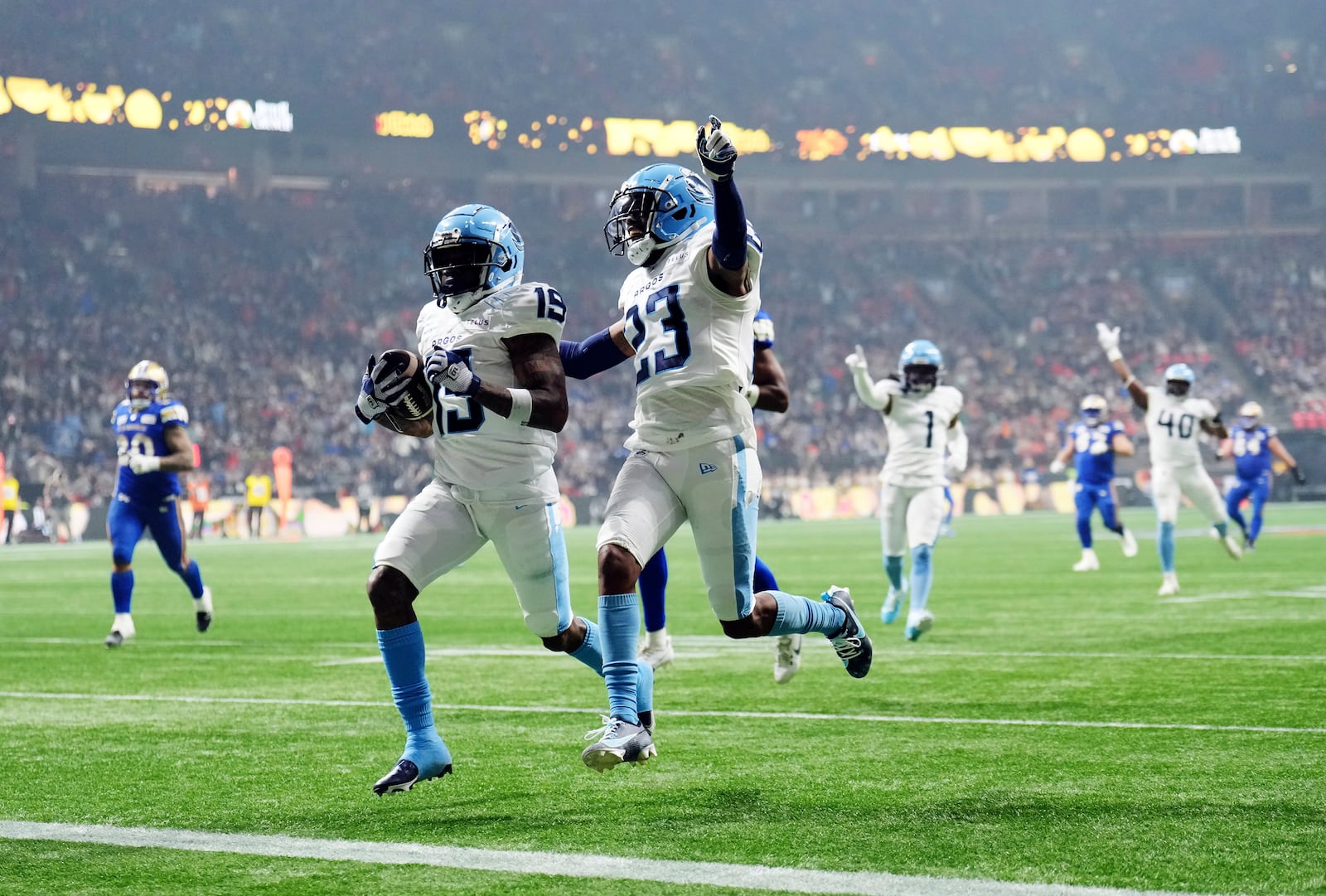 Toronto Argonauts' Robert Priester (19) scores a touchdown after an interception against the Winnipeg Blue Bombers with Benjie Franklin (23) during the second half of a CFL football game at the 111th Grey Cup in Vancouver, British Columbia, Sunday, Nov. 17, 2024. (Nathan Denette/The Canadian Press via AP)