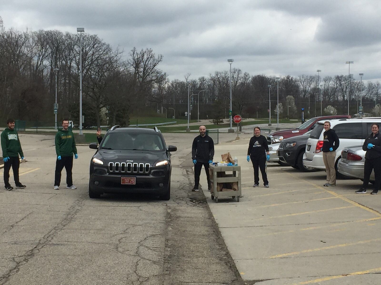 Wright State s athletic training staff hands out lunches this week at a lunch drive-through the Raiders had for its student athletes during the Covid-19 pandemic. CONTRIBUTED