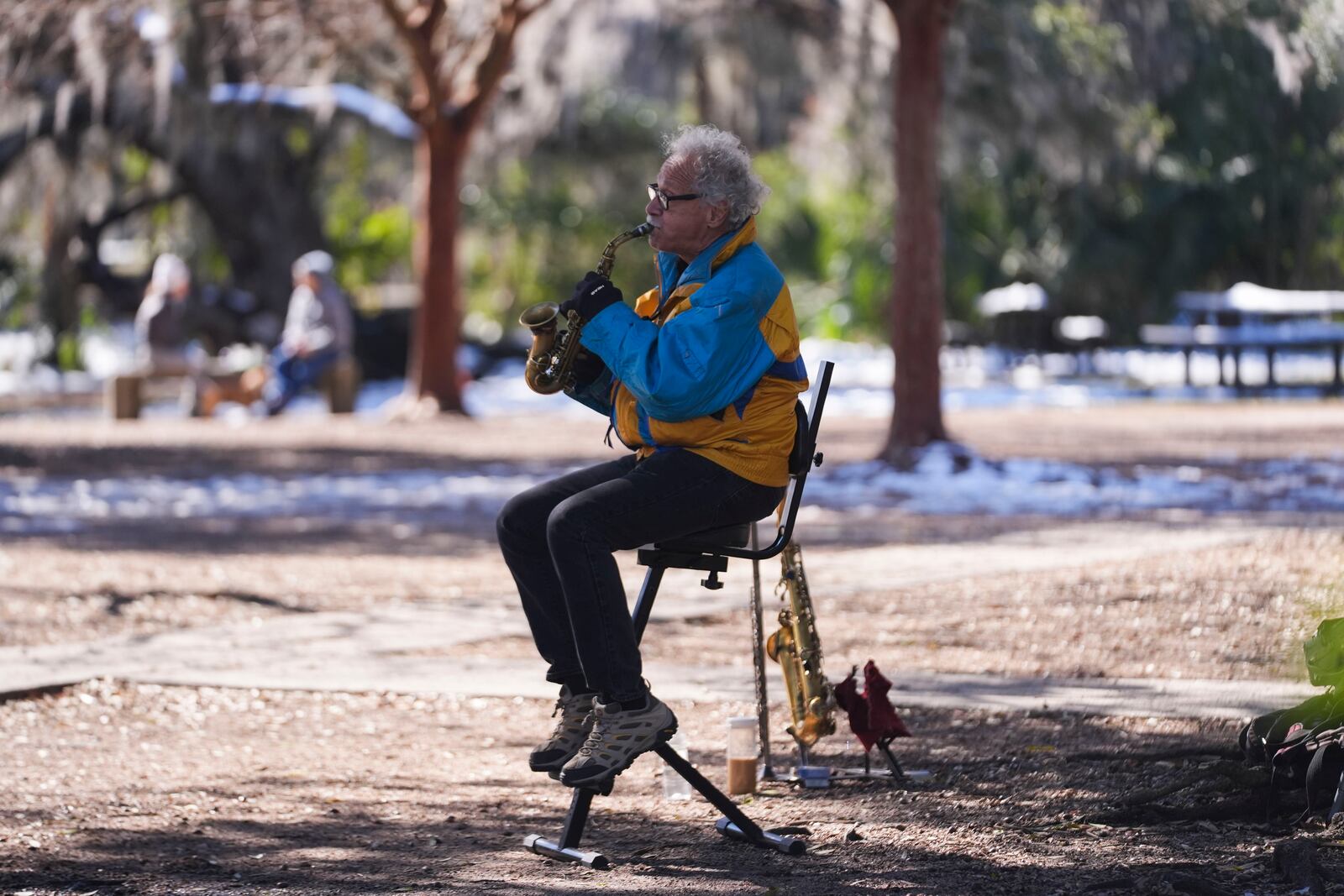 A man plays a saxophone outside Cafe du Monde in City Park in New Orleans, Friday, Jan. 24, 2025. (AP Photo/Gerald Herbert)