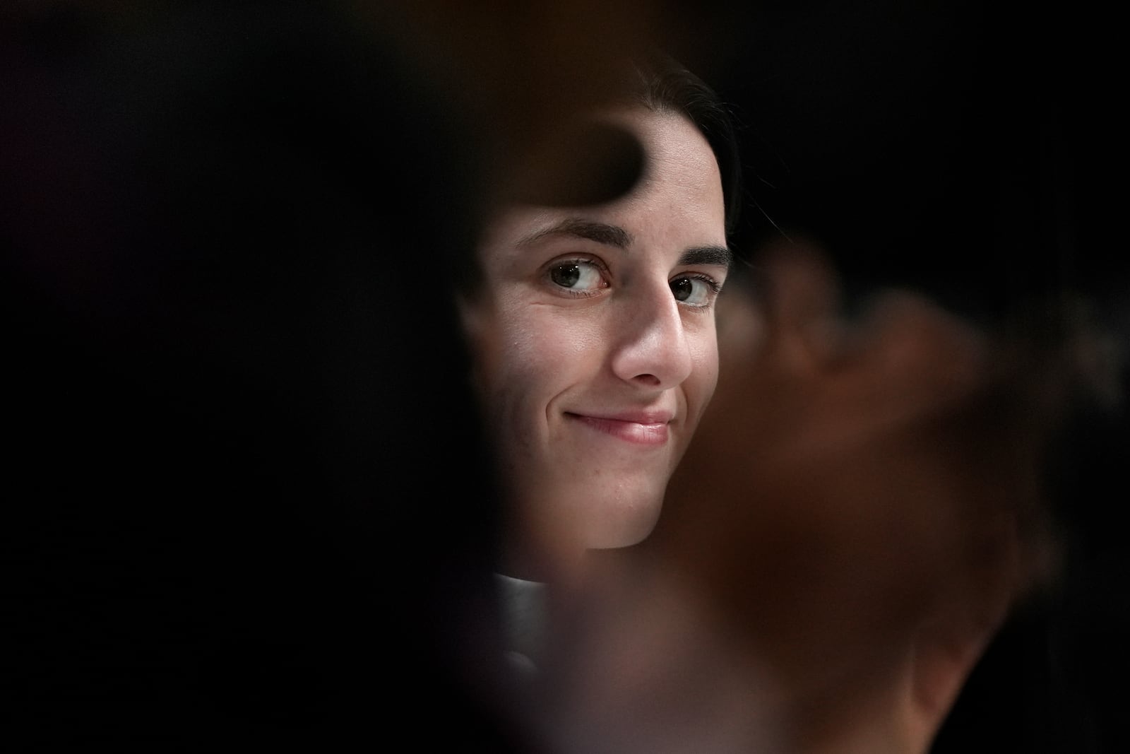 FILE - Iowa's Caitlin Clark looks on during a news conference announcing the AP NCAA Women's Coach and Player of the Year Thursday, April 4, 2024, in Cleveland. (AP Photo/Carolyn Kaster, File)