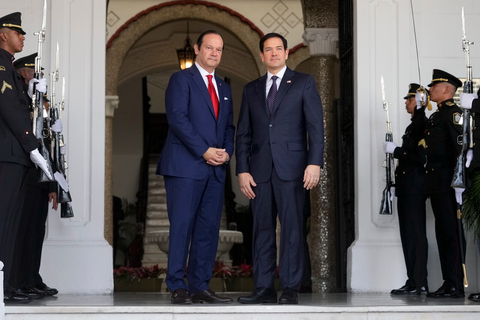 Panama's Foreign Minister Javier Martinez-Acha, left, welcomes U.S. Secretary of State Marco Rubio to the presidential palace in Panama City, Sunday, Feb. 2, 2025. (AP Photo/Mark Schiefelbein, Pool)