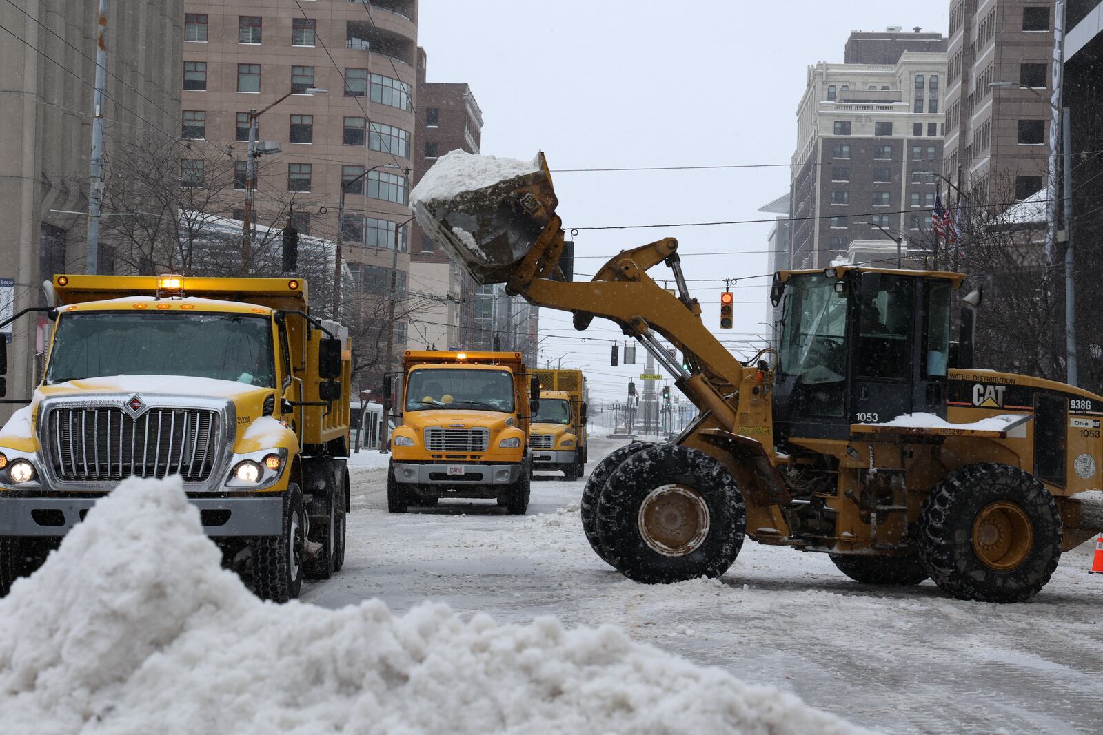 Main Street in downtown Dayton was blocked down to one lane in each direction as city crews used heavy equipment to load the snow into trucks Friday morning.