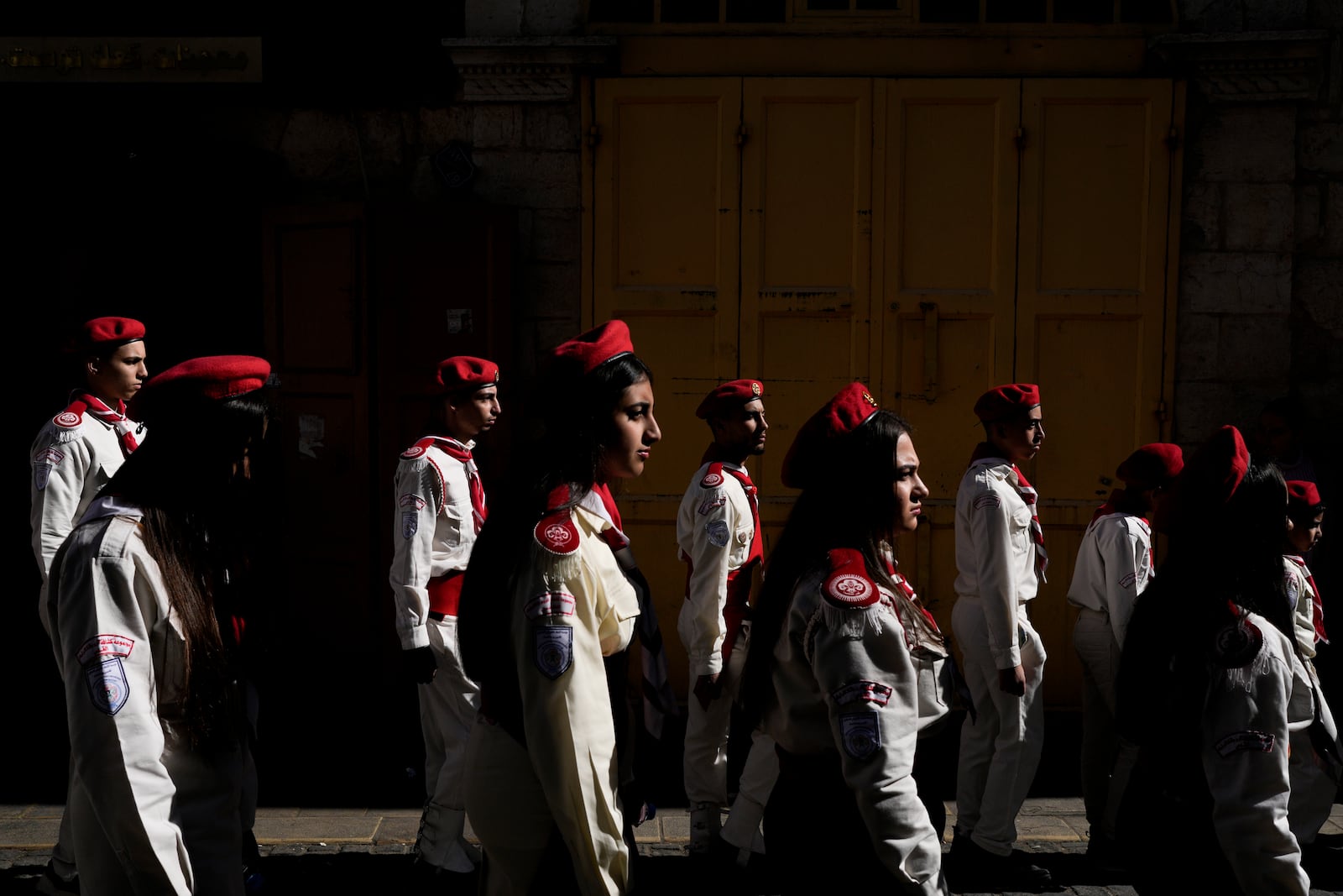 Scouts line up during the traditional Christian procession towards the Church of the Nativity, traditionally believed to be the birthplace of Jesus, on Christmas Eve, in the West Bank city of Bethlehem, Tuesday, Dec. 24, 2024. (AP Photo/Matias Delacroix)