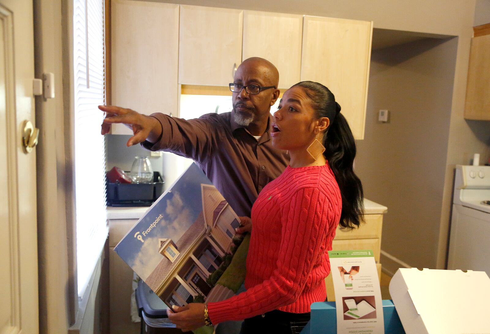 David Singleton, executive director of the Ohio Justice & Policy Center, helped Tyra Patterson install a security system in her Cincinnati apartment. For the the first time in her life Patterson is living on her own. Singleton helped secure parole for Patterson. LISA POWELL / STAFF