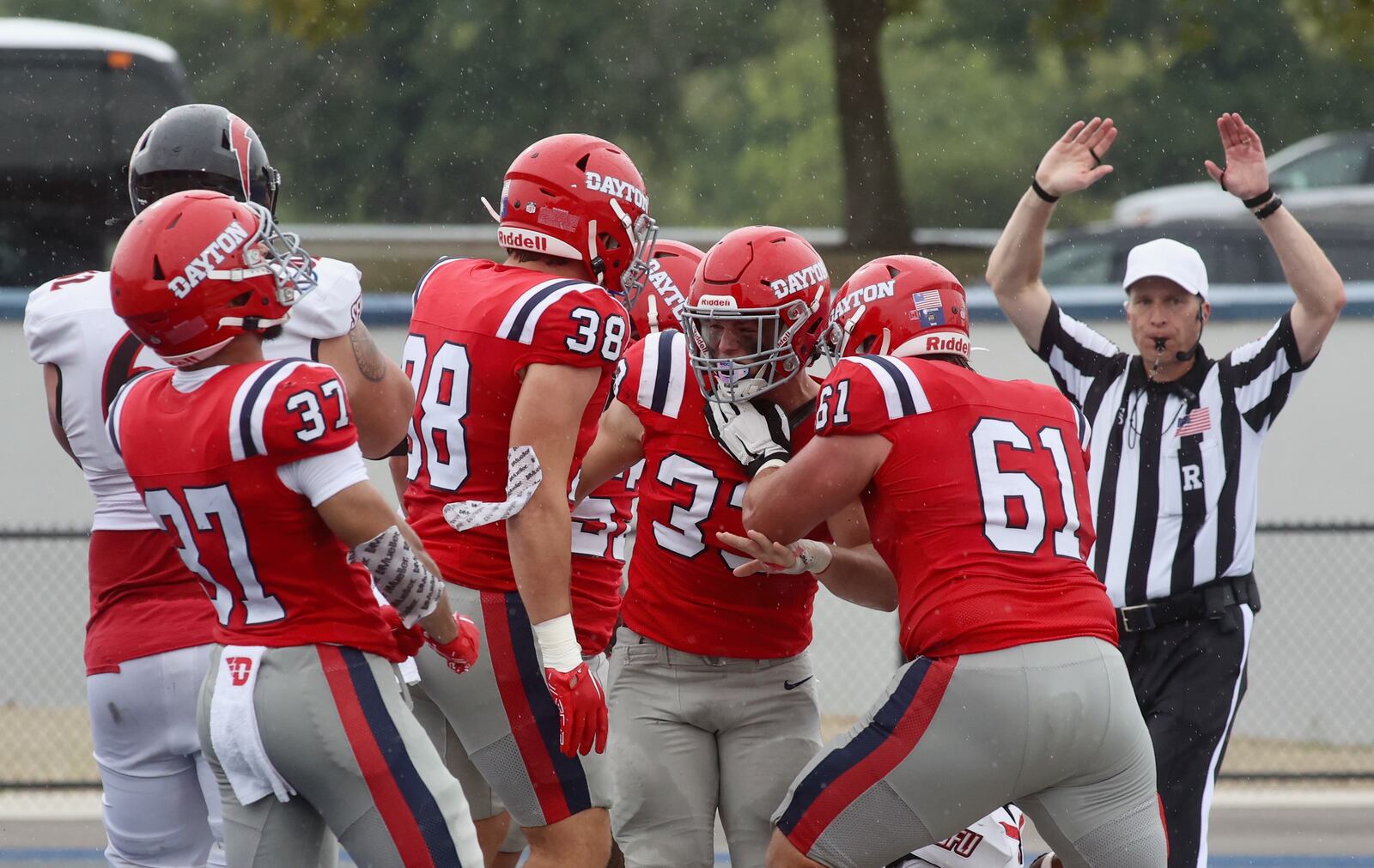 Dayton celebrates a safety forced by Gideon Lampron (33) against St. Francis on Saturday, Aug. 31, 2024, at Welcome Stadium in Dayton. David Jablonski/Staff