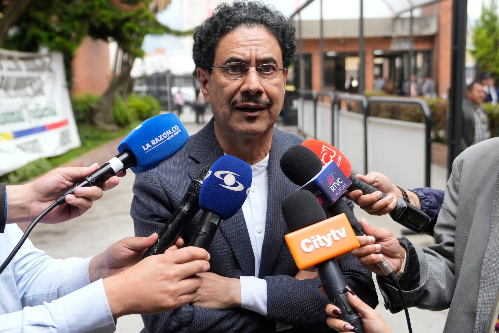 Senator Ivan Cepeda speaks to journalists after attending a hearing in the trial of former President Alvaro Uribe, who faces charges of witness tampering and bribery in a case Cepeda brought against him, in Bogota, Colombia, Monday, Feb. 10, 2025. (AP Photo/Fernando Vergara)