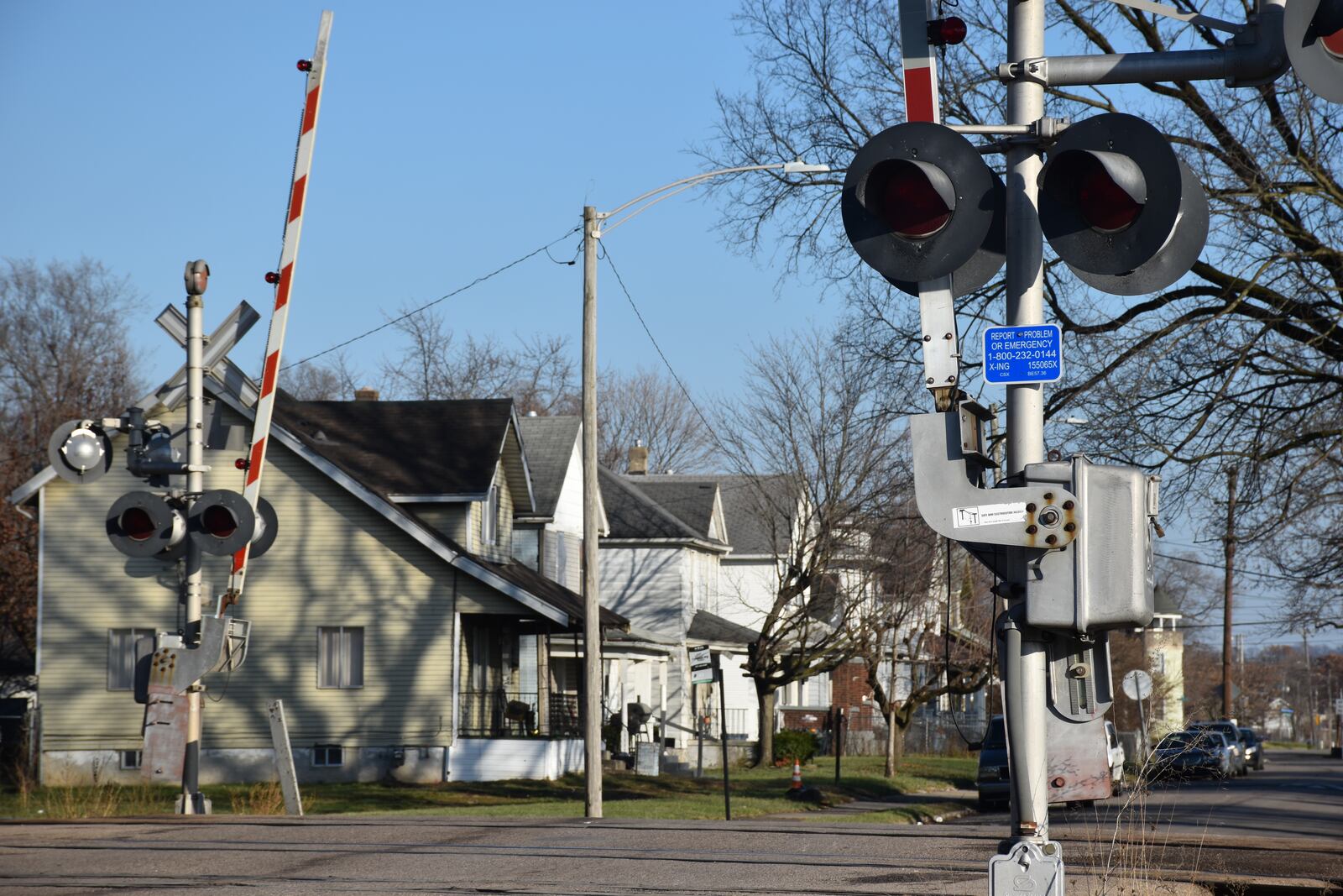 An at-grade rail crossing in Dayton's Edgemont neighborhood near a cluster of homes. CORNELIUS FROLIK / STAFF