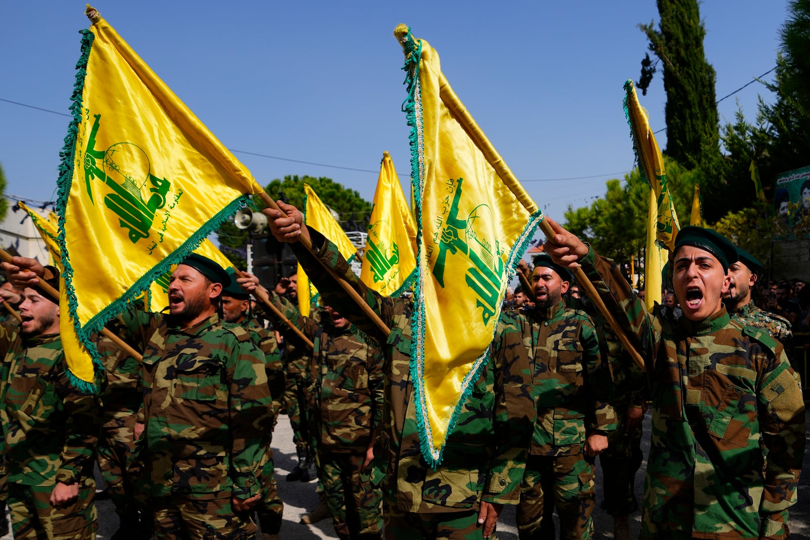 FILE - Hezbollah fighters attend the funeral procession of a Hezbollah militant who was killed by Israeli shelling, in south Lebanon, Oct. 22, 2023. (AP Photo/Hassan Ammar, File)