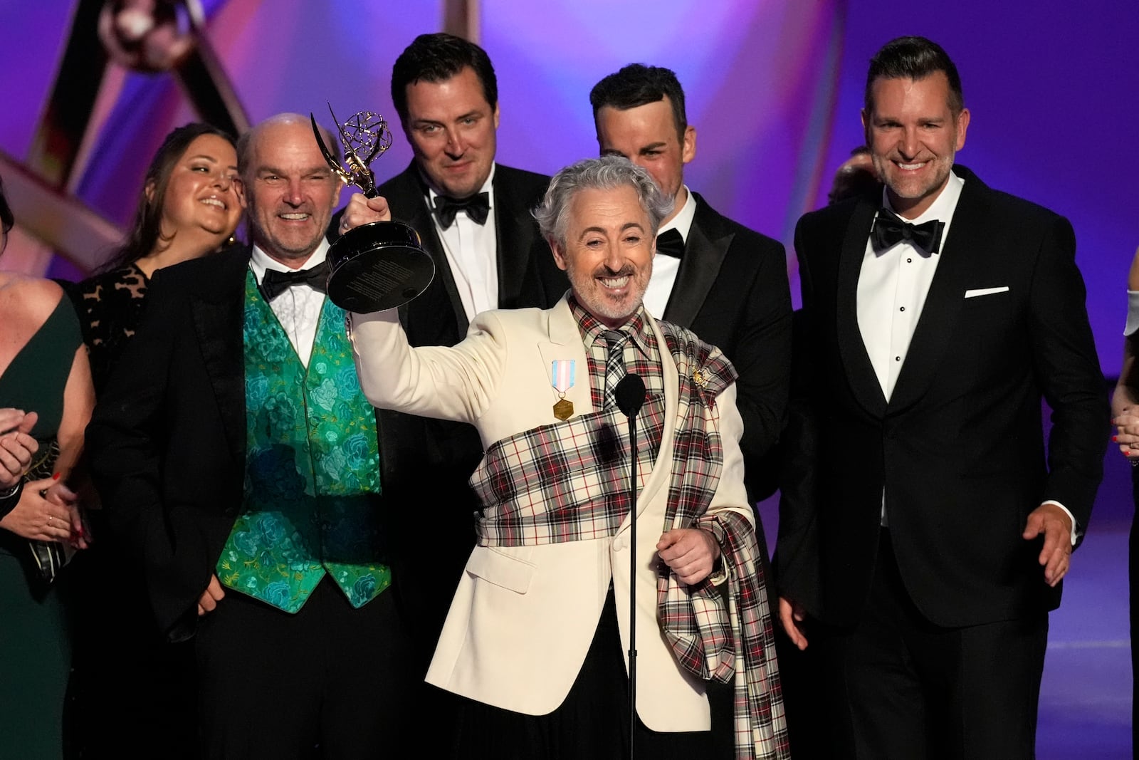 Alan Cumming, center, and the team from "The Traitors" accept the award for outstanding reality competition program during the 76th Primetime Emmy Awards on Sunday, Sept. 15, 2024, at the Peacock Theater in Los Angeles.(AP Photo/Chris Pizzello)