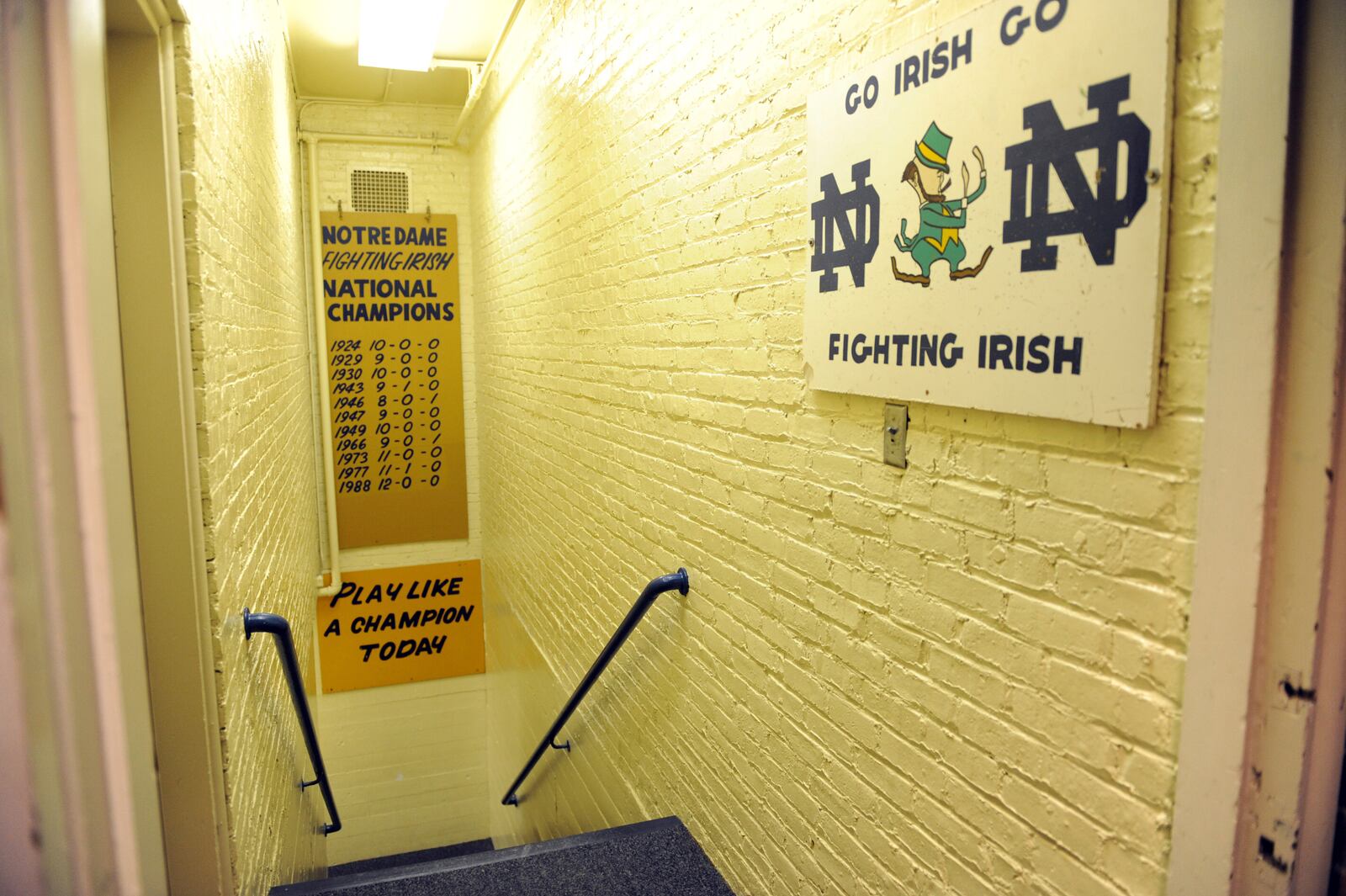 FILE - In this Nov. 21, 2011, file photo, the hallway between the locker room and the field at Notre Dame stadium shows the sign "Play like a Champion Today" in South Bend, Ind. (AP Photo/Joe Raymond, File)