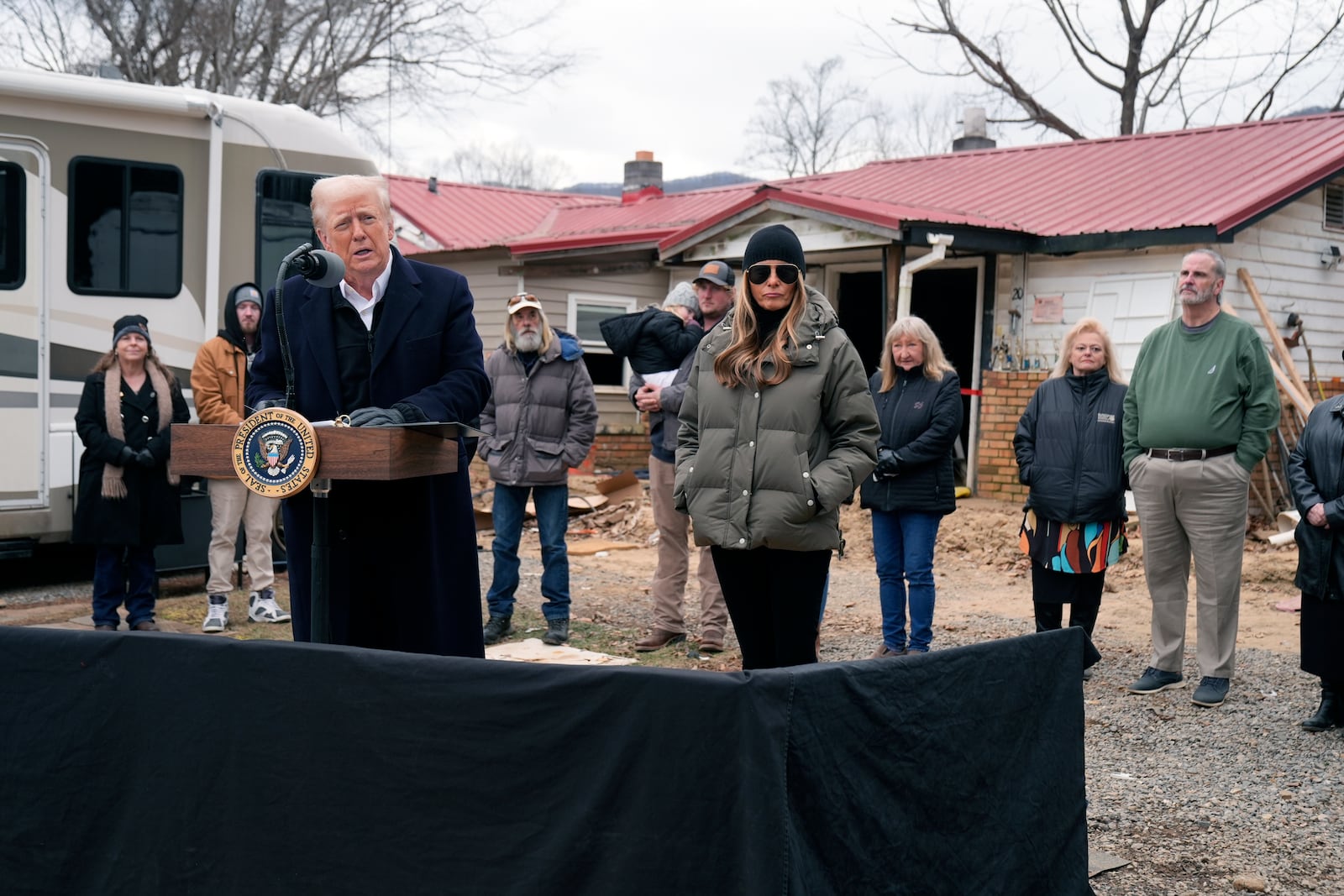 President Donald Trump speaks along side first lady Melania Trump, as they meet with homeowners affected by Hurricane Helene in Swannanoa, N.C., Friday, Jan. 24, 2025. (AP Photo/Mark Schiefelbein)