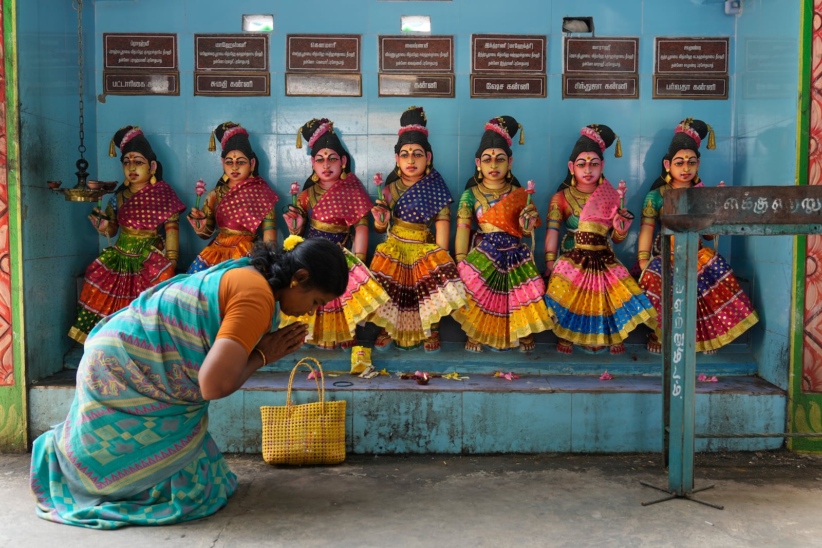 A villager prays in front of the idols of Hindu goddesses after special prayers for the victory of Democratic presidential nominee Vice President Kamala Harris, at Sri Dharmasastha temple in Thulasendrapuram, the ancestral village of Harris, in Tamil Nadu state, India, Tuesday, Nov. 5, 2024. (AP Photo/Aijaz Rahi)