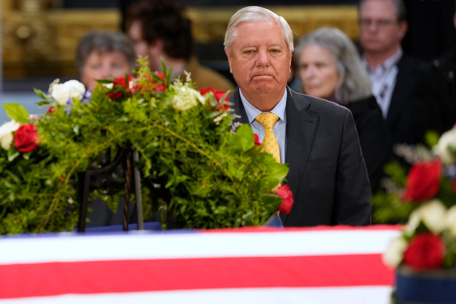 Sen. Lindsey Graham, R-SC., visits the flag-draped casket of former President Jimmy Carter as he lies in state at the U.S. Capitol, Wednesday, Jan. 8, 2025, in Washington. Carter died Dec. 29 at the age of 100. (AP Photo/Steve Helber)