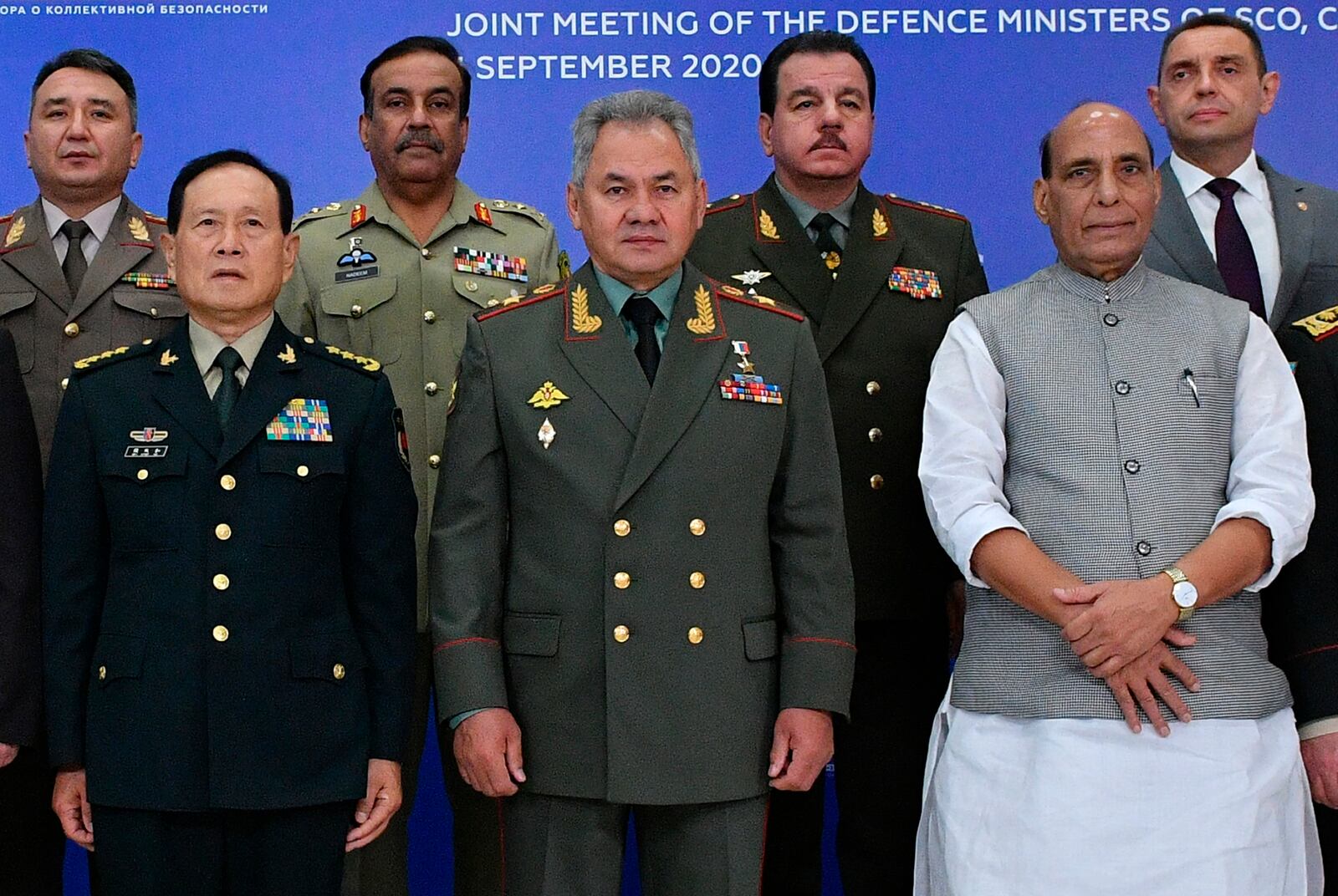 FILE - In this file photo taken Friday, Sept. 4, 2020, China's Minister of National Defence Wei Fenghe, left, Russian Defense Minister Sergei Shoigu, center, and Indian Defense Minister, Rajnath Singh, right, pose for a photo with their colleagues at a Joint Meeting of Defense Ministers of Shanghai Cooperation Organisation, Commonwealth of Independent States and Collective Security Treaty Organization Member States in Moscow, Russia. India and China are accusing each other of violating agreements along their disputed mountain border, even as they engage in talks to end increasing military tensions. (Host Photo Agency sco-russia2020.ru via AP, File) ///