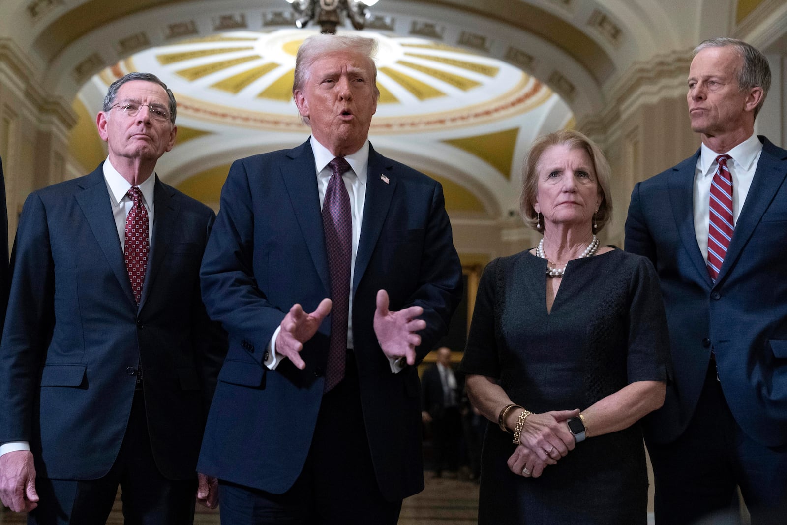 President-elect Donald Trump flanked by Sen. John Barrasso, R-Wyo., left, Sen. Shelley Moore Capito, R-W.Va., and Senate Majority Leader John Thune of S.D. talks to reporters after a meeting with Republican leadership at the Capitol on Wednesday, Jan. 8, 2025, in Washington. (AP Photo/Jose Luis Magana)