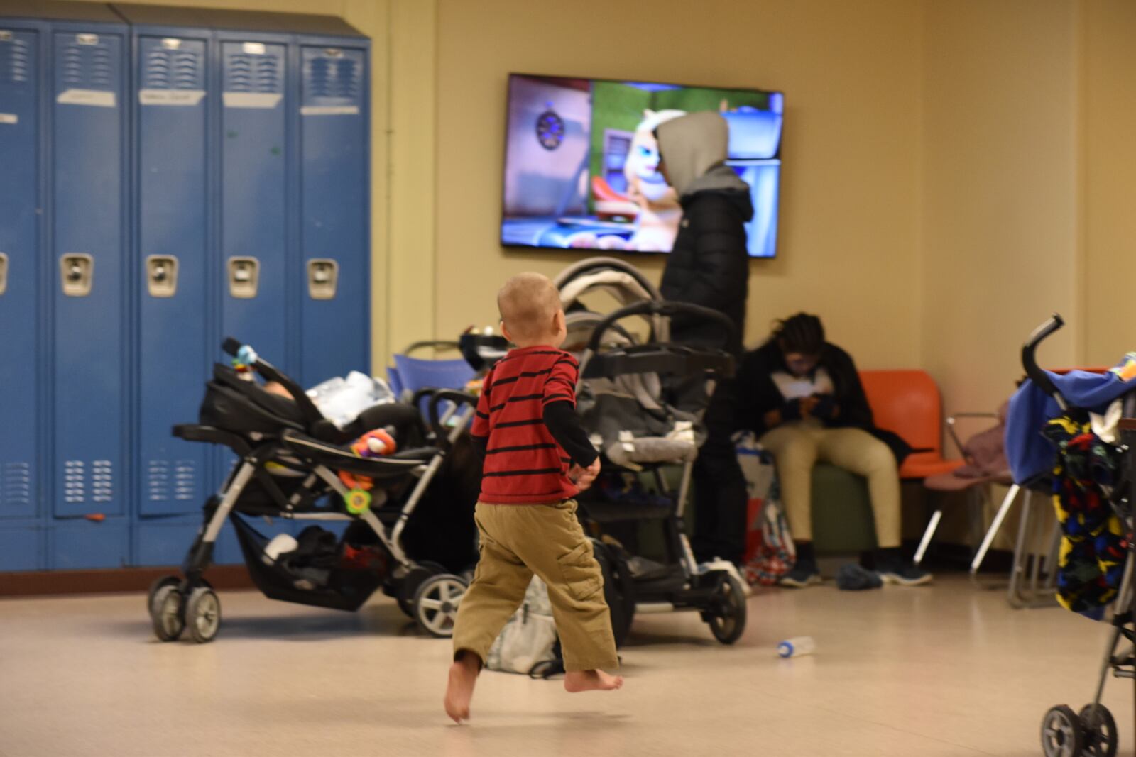 A boy runs around in a family area of the homeless shelter for women and families in Dayton, run by St. Vincent de Paul Society, Dayton. CORNELIUS FROLIK / STAFF