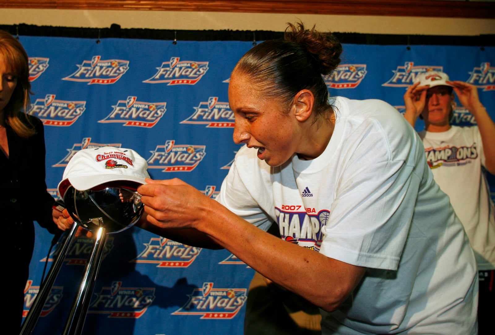 FILE - Phoenix Mercury guard Diana Taurasi places her champions cap on the WNBA basketball finals trophy at the Palace of Auburn Hills, Mich., Sunday, Sept. 16, 2007.. (AP Photo/Gary Malerba, File)