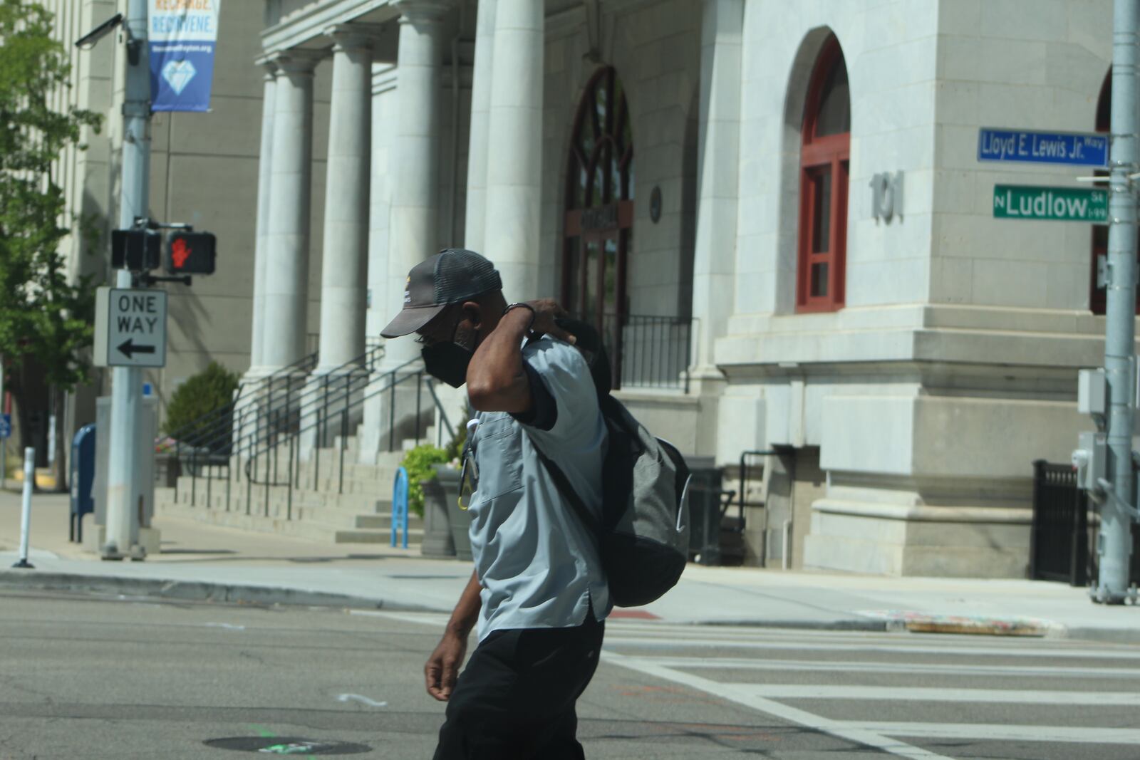 A man crosses West Third Street in downtown Dayton on Monday. Dayton City Hall can be seen in the background. CORNELIUS FROLIK / STAFF