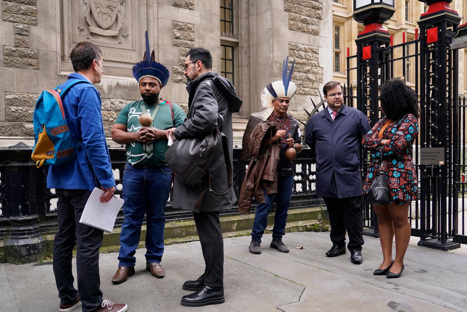 Protesters stand outside the Royal Courts of Justice in London Monday, Oct. 21, 2024, as lawyers representing around 620,000 Brazilians as well as businesses, municipal governments, members of the Krenak indigenous tribe are bringing a multibillion-pound legal action against BHP Group following the collapse of the Fundao dam in November 2015. (AP Photo/Alberto Pezzali)