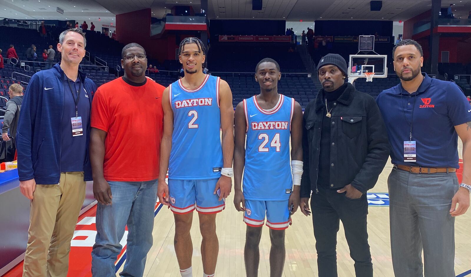 Members of the 2002-03 Dayton Flyers pose for photos with current Flyers on Friday, Nov. 11, 2022, at UD Arena. Pictured from left to right are: Keith Waleskowski; Nate Green; Toumani Camara; Kobe Elvis; Ramod Marshall; and Brooks Hall. Contributed photo